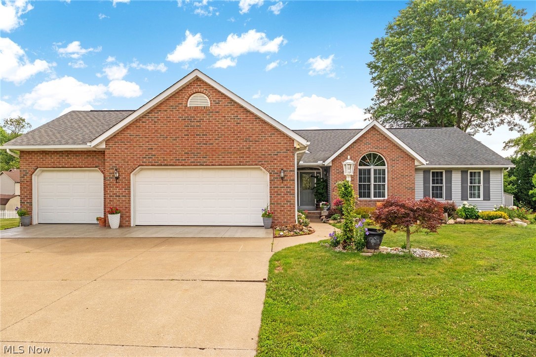Stunning ranch listing in Perry Local Schools with 3 bedrooms, 3 full bathrooms, and 3-car garage! The open concept living has a ton of natural light create an inviting flow from room to room. Step inside to a grand entrance foyer featuring a custom 6-panel door with sidelights, transom, marble floors, and a chandelier. The open living room showcases vaulted ceilings, new skylights with remote blinds, a custom fireplace with wood mantle, and raised marble hearth—perfect for cozy gatherings and stylish entertaining. The large kitchen is a chef’s dream, updated with quartz countertops (2024), newer stainless steel appliances- a double oven range, oversized refrigerator, built-in microwave, and a tile backsplash. Ample cabinetry, a functional bar, and a dining area provide generous storage and flexible seating for everyday use and special occasions. A spacious master bedroom offers French doors, a vaulted ceiling, and a chandelier. The master ensuite features two vanities, a glass-enclosed shower, a jetted tub, and a bidet. Two additional well-sized bedrooms with solid core wood doors share the main-level full baths, ensuring comfort for family and guests alike. The first-floor laundry room with a utility tub adds practical daily convenience. The finished basement expands living options with a large finished space, extra storage, and roughed-in plumbing. Exterior highlights include landscaped rock and mulch beds, a wood deck, and a storage shed- the perfect outdoor space! Recent improvements add ease of living: remote-controlled skylight blinds (2025), leaf guards (2025), front garage cement wash/seal (2025), new HVAC (2024), new hot water tank (2022), and a reverse osmosis system. Additional features: Hoover whole house vacuum system, 6-panel foyer doors, alarm system. Convenient to shopping, restaurants, groceries, and minutes from major highways, this home balances relaxed living with effortless access to everything you need. Schedule you private showing today!