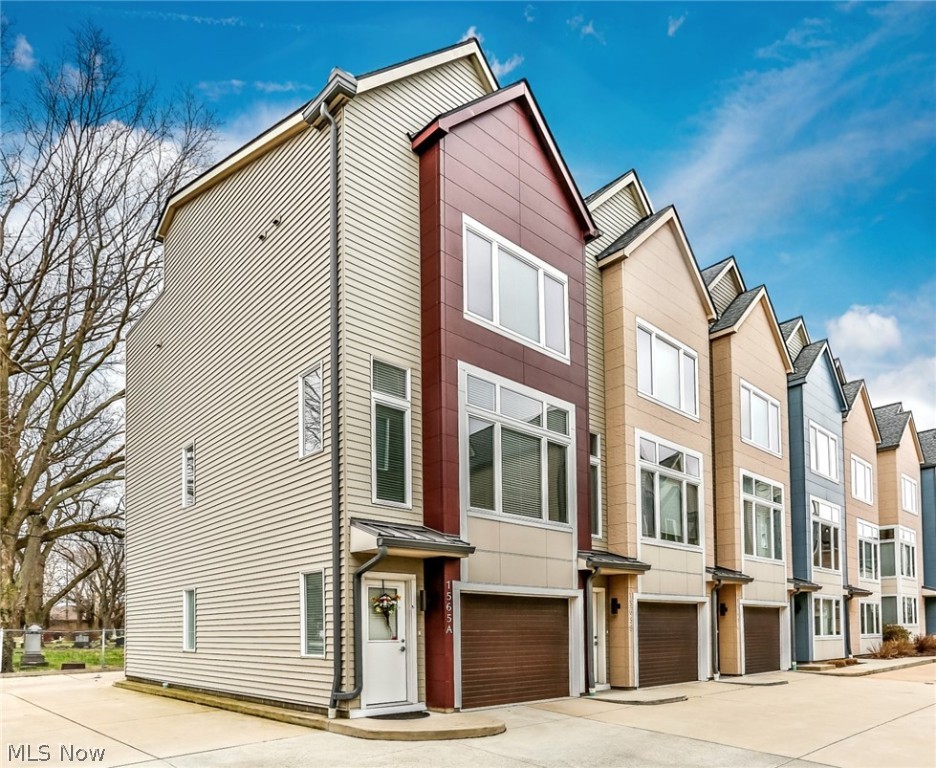 Extremely well maintained 6 years new desirable end unit townhome with lots of light. Many upgrades added in this open layout with soaring ceilings & bamboo wood flooring in main living areas, carpeted bedrooms & tile baths. Stylish kitchen w sleek wood cabinetry, granite counters, stainless upgraded refrigerator & gas cooktop oven. Spacious master bedroom w/walk in closet and on suite bath w/tiled shower, granite sink vanity. 2nd bedroom and 2nd full hall bath inc tub/shower w granite vanity & conveniently located upstairs laundry. Custom window treatments throughout entire house. Desirable rooftop deck perfect for cooking out or relaxing overlooking peaceful setting. 2 car attached garage w front & back entry, epoxy garage floor, & plenty of extra storage room. University Place Townhomes are nestled in the heart of Cleveland's cultural district and offer an excellent proximity to the Cleveland Clinic, University Hospitals, and schools in a nationally recognized neighborhood full of c