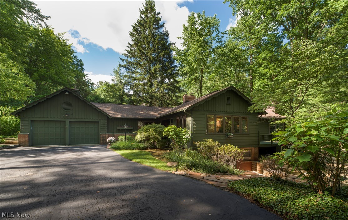Exuding elegance with comfort, an impressive Ranch designed by renowned architect Roy Firestone is situated in desirable Fairlawn Heights (West Akron).  Built in 1949 for the original owner of Swenson's Drive-In, Mr. Firestone was able to tuck this property neatly into the wooded landscape, offering seclusion and beauty amidst its landscaped setting.  Mature perennials and varietal trees line this gorgeous property.

Built in the style of European country retreat, this home is simply unique.  Featured highlights include Great Room with open truss-work, wormy chestnut paneling - a rare luxury and fireplace, formal dining room, beautiful kitchen with granite countertops, butcher block island, high end appliances, library with built in bookshelves and fireplace, all season room, primary suite with glamour bath and walk in closet.  

Elevator brings you to the lower-level living suite with a kitchenette and walkout.  

Updates include HVAC 2025, Roof 2024, Chimney 2026, Bosch Dishwasher 2025.  Four Bedrooms, 3.5 Baths. 

Meticulously maintained, this home awaits you.  Schedule your private showing today.
