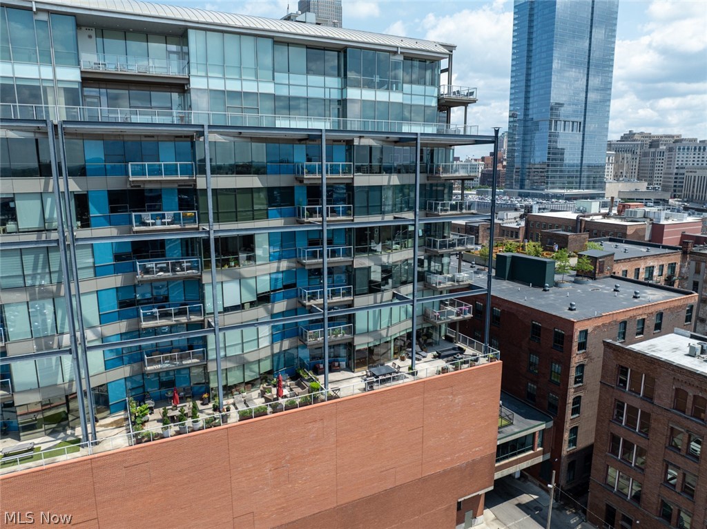 Welcome to Unit 606 at The Pinnacle, an extraordinary corner residence. Floor-to-ceiling curved glass walls wrap the southwest corner, filling the home with natural light and showcasing panoramic views. The open-concept living space flows seamlessly to the home's standout feature. A remarkable private terrace offering generous space for outdoor dining, entertaining, grilling, multiple seating areas, and even an urban garden. It's a rare opportunity to enjoy expansive indoor-outdoor living in the heart of downtown. Located just moments from renowned restaurants, the Flats East Bank, Playhouse Square, and Ohio City, this residence places many of Cleveland's top destinations within easy reach. Residents of The Pinnacle enjoy premium amenities, including a fitness center overlooking the harbor and stadium, saunas, 24-hour security, concierge services, a dedicated pet area, and two parking spaces.