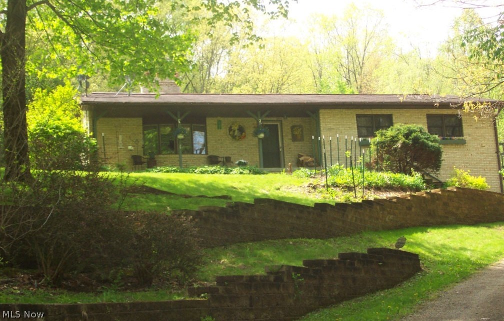 Nature lovers retreat. Excellent all brick ranch home on 2.3 quiet, private acres. Spacious living room with bay window and an awesome natural stone fireplace with raised hearth to sit on to enjoy the fire. Beautiful sunny kitchen with stone feature wall and plant window. Awesome setting with curving retaining walls and lovely patio with an outdoor fireplace. Gorgeous new $10,000 bathroom (2013) with granite vanity and jet tub. Master bedroom with private deck. Rec room with wood stove and adjoining full bath. Heat with electric or the efficient pellet stove. Country living close to town, the freeway, and the lakes. Laundry hookups on both floors. Awesome landscaping. Stained glass decorations are excluded in sale. Fuel cost for these sellers are electric averages about $150 per month winter, $128 per month summer. Pellets for the pellet stove about $700 for an entire winter. Nice turn around area on concrete apron next to garage at the top of driveway.  Bring your offers.