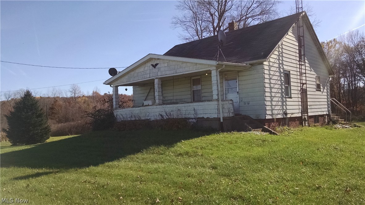 If you're looking for a quiet country home and some acreage this is it.  Plenty of room to roam on the 20+ acres  with 2200 feet of frontage.  The 3 bedroom house needs some TLC but is sound and with a little elbow grease and a small investment it will be a great place for a family.  This is an easy keeper.....FREE GAS to the house.  With the money you save on heating you can fix the house up.  An easy drive to Canton, New Philadelphia and the interstates.