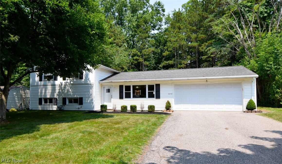A must see home with a lot of love to give! Situated on a spacious wooded lot, this charming split-level home offers incredible potential for buyers looking to make a home their own. With a functional open-concept layout, this property provides a wonderful foundation for renovation and personalization.

The inviting living room and family room showcase beautiful ceramic tile flooring, while the kitchen is equipped with granite countertops, a breakfast bar, and opens seamlessly to the main living areas?ideal for everyday living and entertaining. An oversized attached two-car garage offers ample space for parking, storage, or a workshop.

Enjoy the peaceful setting from the welcoming front porch or relax on the rear patio complete with an awning, overlooking the expansive backyard.

Conveniently located near parks, shopping, schools, a fitness center, the award-winning library, and many other local amenities, this home combines an outstanding location with endless possibilities. Whether you?re an investor, first-time buyer, or someone ready to create your dream home, this is an exceptional opportunity to build equity and add your own personal touch. Call today for a private showing!