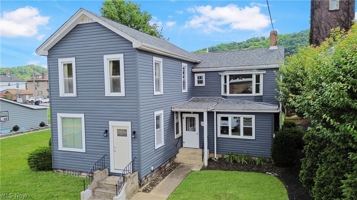 A rare opportunity to own one of the area's most recognizable historic residences. Originally dating back to the early 1800s, this stately home combines generations of craftsmanship, character, and history with the space and functionality today's buyers appreciate.

Positioned in the heart of town beside the beautifully maintained World War I Memorial Plaza, this landmark property enjoys a setting unlike any other. Surrounded by historic churches, civic buildings, and riverfront amenities, you'll love the charm, walkability, and sense of community that this location provides.

Inside, the home offers an impressive amount of living space with 11 rooms, 3 full baths, and 3 half baths. Large gathering areas, spacious bedrooms, original woodwork, and timeless architectural details create a warm and inviting atmosphere throughout. The versatile floor plan provides endless possibilities for multi-generational living, a home office, guest quarters, or simply room to spread out and enjoy.

A significant addition completed in the late 1950s expanded the home to include a generous kitchen area, private primary suite with its own bath, and an attached two-car garage. Numerous exterior improvements over the years, including updated siding, windows, doors, and roofing, have helped preserve the home's integrity while reducing maintenance concerns.

Whether you're drawn to the property's historical significance, its prominent downtown location, or the opportunity to make a truly distinctive home your own, this residence offers a combination of character and potential that is seldom available. Rich in history, filled with charm, and ready for its next chapter, this is a property that must be experienced in person.