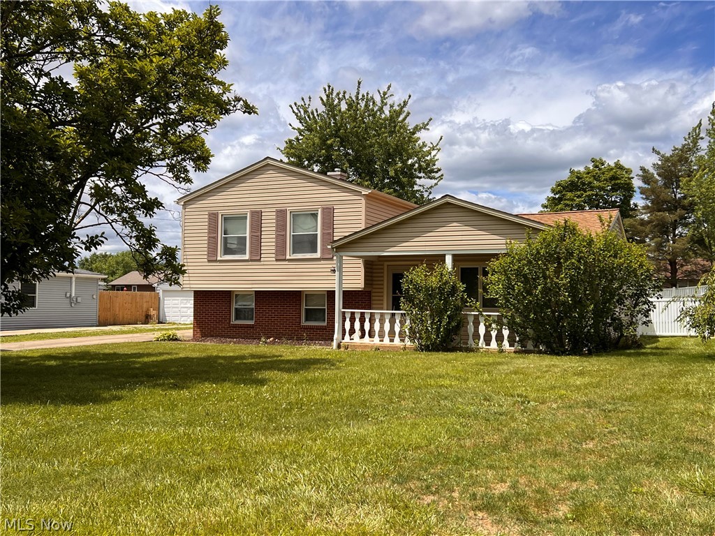 Welcome home to this well maintained split-level residence in the desirable College Park area of Austintown! Built in 1960 and proudly owned by the same family for decades, this one family owned home reflects years of care. Situated on a beautiful quarter-acre lot, the brick and vinyl-sided exterior is complemented by mature trees, covered front porch, and attractive front and back yards.

Step inside to a spacious living room filled with natural sunlight from the large windows. The eat-in kitchen includes a refrigerator, gas range, and dishwasher, offering plenty of space for everyday meals and gatherings. Upstairs, you’ll find three bedrooms and an updated full bath featuring a walk-in shower and bidet. If paneled walls aren't to your liking, there's plenty of options to change them to match your desired decor.

The lower level offers a comfortable family room, a second full bathroom, and a utility room housing the gas furnace, 40-gallon hot water tank, electrical panel, and washer and dryer, which will remain with the home. Convenient access from the utility room leads directly to the backyard.
The enclosed patio is surrounded by large windows overlooking the beautiful back yard! Enjoy the peace and serenity of nature while sipping on your favorite beverage. The vinyl, privately fenced in backyard allows pets and children to run and play. The backyard features a storage shed for all of your lawn implements. The concrete driveway offers convenient parking for guests, while the oversized 2.5 car detached garage provides lots of space for vehicles and toys.

Major updates include a new roof (2021) & central air conditioning (2023). Additional features include an Ohio State Waterproofing transferable warranty and a home warranty provided for added peace of mind. Located in a well-established neighborhood close to shopping, dining, parks, and everything Austintown has to offer, this cherished home is ready for its next chapter. Call to schedule your tour today!