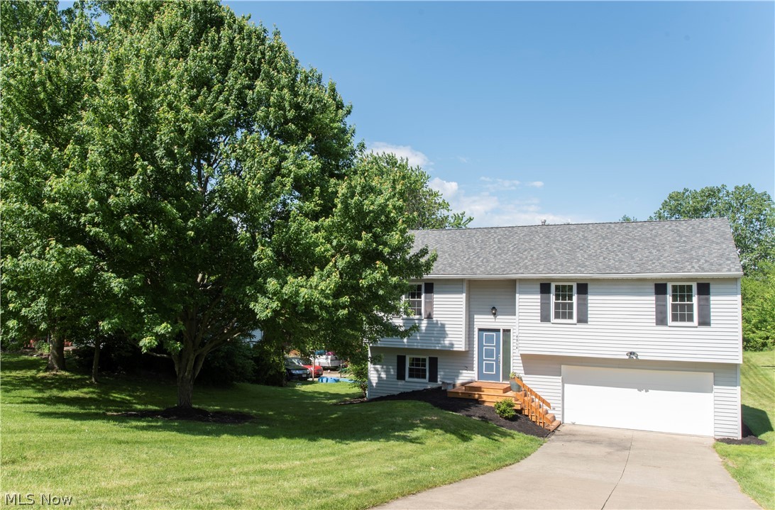 Welcome Home to this exceptionally well maintained property in Medina! This modern, updated and open floor plan is sure to delight.  Vaulted great room is open between the beautifully upgraded kitchen with breakfast bar, to the dining room to the living room.  Off the dining room is a lovely 12x12 deck overlooking a spacious treed lot. Down the hall you will find great bedroom sizes and ample closet space.  Unique bathroom layout includes a Jack and Jill full bath plus an additional half bath.  The walk out lower level offers large sunny windows, a spacious family room, another FULL bath, a spacious laundry room and the attached 2 car garage.  Many updates throughout including  bathroom Reno's 2020, new kitchen counters and cabinets 2018, floors 2017,  a/c in 2018, roof in 2012,  smart garage door opener 2015,  windows 2014, furnace 2011- just to name a few!  Nothing to do but move in.  Dont miss this one!