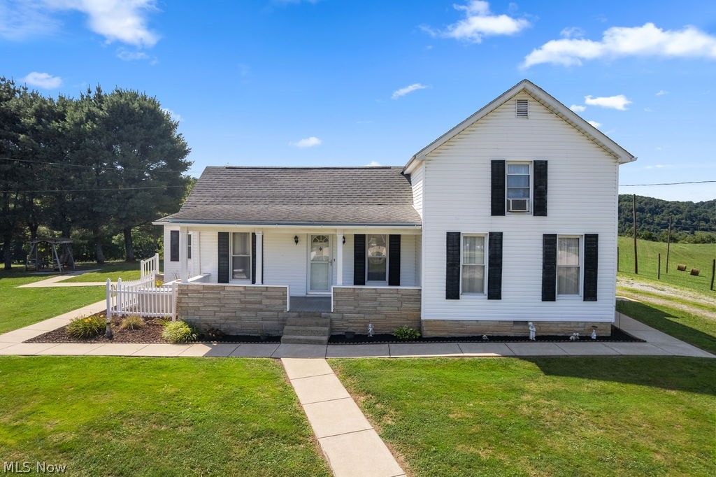 For the first time on the market in 60 years, this lovingly cared-for farm house on 3 acres is available for a new generation of owners.  Built in 1940, this iconic home in the heart of Elizabeth has been impeccably maintained over the years.  The main level features a large primary bedroom with beautiful hardwood floors, a sitting room, and a nice full bath with a custom tiled walk-in shower.  An expansive living room connects to the eat-in kitchen, and the back end of the house has a versatile sunroom space which leads to a laundry/utility room.  Two more bedrooms are on the upper level on either side of the stairs.  This is one of those homes that just "feels good"- giving a cozy, comforting vibe throughout.  The home's exterior has been modernized with vinyl siding for easy maintenance, and a whole house generator gives peace of mind in case of outages.  The rolling 3 acre parcel is cleared for a serene setting leading all the way back to the woods.  A detached garage adds convenience and security, and another outbuilding and a large open-front shed offer plenty of extra storage space!  Sit on the front porch and watch the cars go by, or retreat to the swing underneath the pine trees.  This home hints at a simpler time, while still providing modern amenities for today's lifestyle.  Don't miss your opportunity to own this Wirt County gem!