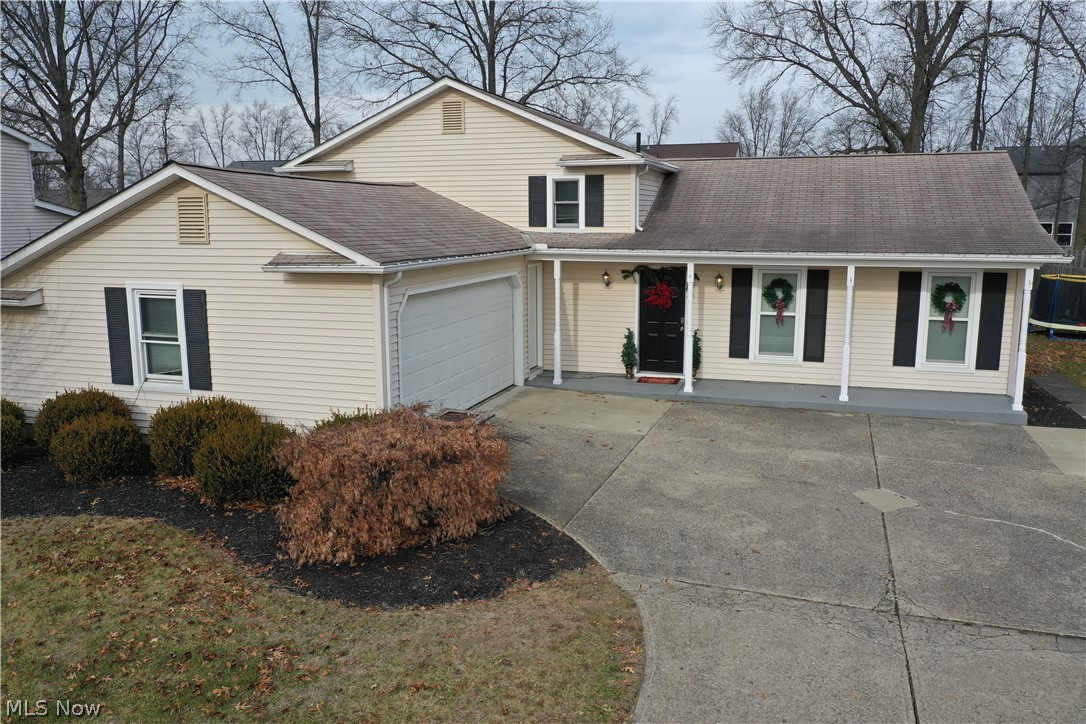 Welcome home to this beautiful Split level in the heart of North Ridgeville! Imagine yourself sitting on the lovely, covered front porch sipping a cup of coffee. This 3 bed, 2 full bath home, displays pride of ownership and has been updated with neutral paint throughout. The kitchen features plenty of storage with gleaming white cabinets, gorgeous tile back splash and stainless steel appliances. The living room has beautiful hardwood flooring & is open to dining room. The dining room has sliding doors for convenient access to the concrete patio and the spacious yard. This home is situated on a large lot with a shed, that adds space for your yard tools, bikes, etc! The lower level family room features a cozy wood-burning fireplace, which makes this a great space for family & friends! The Master bedroom includes an attached en suite bathroom. The Laundry room is spacious with a closet for additional storage to help you stay organized. This home is completed by an over-sized attached gara