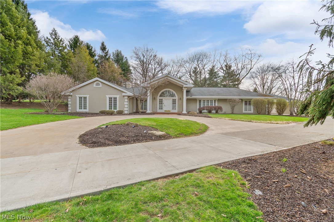 Impressive 5083 sq. ft. ranch home nestled on 2.46 private, picturesque acres in prestigious Hills & Dales community.  Designed for both elegant entertaining & comfortable everyday living, this spacious residence also features an additional 1500 sq. ft. suite on the lower level.  An inviting Foyer welcomes you, flanked by a handsome Library on one side and a gracious Living and formal Dining Room on the other.  The fully equipped gourmet Kitchen boasts upscale appliances, a butler's pantry and generous workspace that makes meal prep enjoyable.  Expansive Family Room with a 4th fireplace, wet bar, cathedral ceiling & built-ins.  Master Bedroom retreat features a luxurious spa-inspired Bath and abundance of closet storage.  Warm, elegant and timeless appeal.