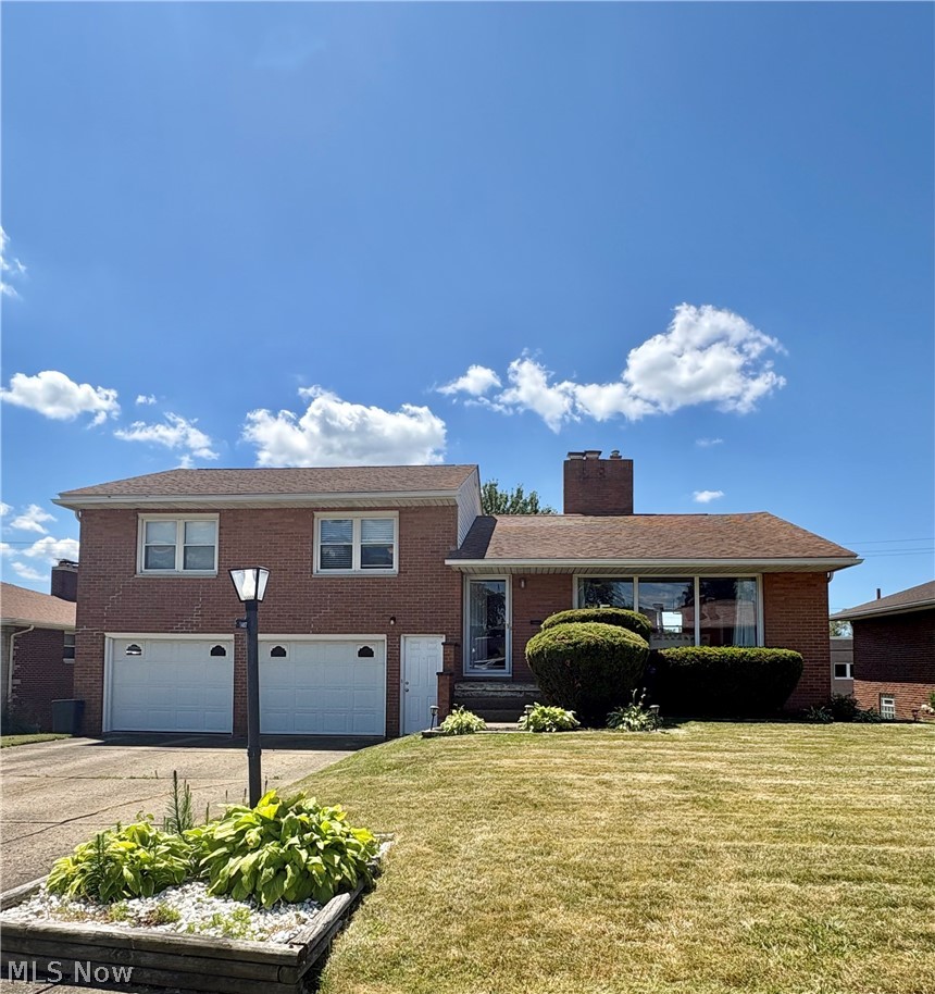 This beautiful brick 3 bedroom 2 bath home has great space inside and out. This home features a spacious kitchen with double oven, cooktop, refrigerator. The dining room has updated lighting, laminate floors, built in storage bench seating and sliding door to the deck. There is wonderful gathering space both on the main level and the lower level with spacious living room and family room. The three bedrooms all have lovely neutral carpet and plantation blinds and double closets with the primary bedroom having two double closets.  THe Lower level has a combination laundry utility room and a bath with a shower.  There is a great storage room/workshop room at the back of the two car garage. This home is on a nice sized lot with a great backyard and features a ptio as well as a trex deck with stairs to the backyard.
