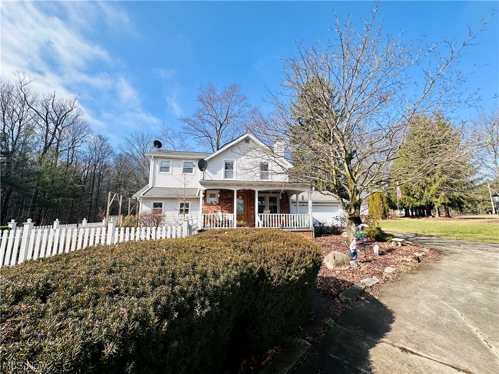 You'll find your own personal paradise on this sprawling two acre property with charming brick walkways, fenced garden, deck, pavilion, basketball court and scenic views from every angle. The turn-around driveway provides easy entry to the oversized two car attached garage with a rear garage door for quick backyard access. From the moment you enter this house, you're greeted by an array of classical architectural details such as wood floors, brick fireplace, arched doorways, intricate moldings and wood beams. All add to the charm and character of this wonderful residence. The generous living space includes a formal living and dining rooms, den, kitchen with appliances, informal dining area and full bathroom. The star of this level, however, is the expansive step-down family room addition showcasing a cathedral ceiling, skylights, walls of windows, fantastic second floor loft and stunning views of the property. Imagine the parties you could host in this space! The second floor provides a large primary bedroom with his & hers closets, plus two guest bedrooms, full bath and access to the loft. This home features plentiful storage throughout including a basement, large laundry/mud room off of the garage and attached storage shed to keep your belongings safe and well-organized. This property will exceed your expectations. Schedule a private tour today!