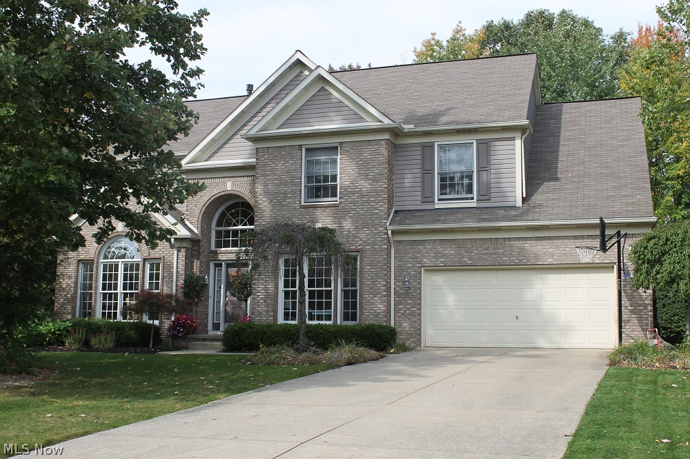 Open, bright and updated is this 4 bedroom, 2 ½ bath Twinsburg home on a quiet Cul-De-Sac in Ethan’s Green located on a beautiful wooded private lot that backs to Gleneagles golf course.  Dramatic 2 story foyer with spiral staircase opens to the living/dining room with arch details and tray ceiling.  The huge updated kitchen includes all stainless steel appliances and tons of cabinets with walk in pantry which opens to the soaring 2 story great room with gas fireplace.  A first floor office and laundry room complete the first floor.  Relax in the vaulted master suite or soak in the oversized tub in the spacious master bathroom.  Plenty of space in the walk in closets and 3 other bedrooms upstairs.  The finished lower level is perfect for movie night or a play room.  Enjoy dining al fresco on the brick patio with peaceful water feature and lush greenery.  Highly rated Twinsburg City schools, minutes to 480, 422 & Route 8, and less than a mile to Heinen’s grocery store.  Twinsburg city a