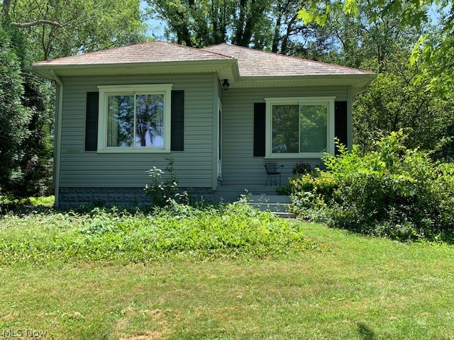 Cute bungalow situated on 3.99 acres m/l offering updated eat-in kitchen with stove, refrigerator, and dishwasher, updated bath with garden tub, separate shower, nice size living room with doors to side deck, two bedrooms.  Basement offers laundry hookups, storage, you decide!  Two car detached garage with one door opener.  Shed and above ground pool.