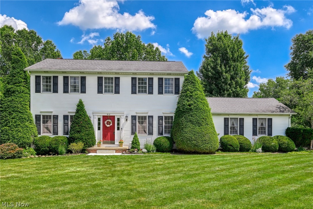 Welcome home to this beautifully maintained 4-bedroom, 2.5-bath colonial situated in one of Tallmadge’s most highly desirable neighborhoods! From the moment you arrive, the professionally landscaped yard and incredible curb appeal will captivate you. The main level offers a spacious layout featuring both a living room and a family room, along with a formal dining area perfect for hosting. The oversized kitchen is a chef’s delight, boasting a large peninsula with stunning granite countertops and stainless steel appliances, opening seamlessly into the family room area for an expansive, airy feel. Gorgeous wood floors grace the foyer, hallway, kitchen, and the family room, which centers around a wood-burning fireplace. A convenient first-floor laundry room adds to the home's effortless functionality. Downstairs, the partially finished basement expands your living space with an additional recreation room, a dedicated workout room, and ample space left over for a workshop and storage. The outdoor oasis features a private brick patio overlooking a gorgeous, serene setting. Don’t miss your chance to call this Tallmadge gem home!