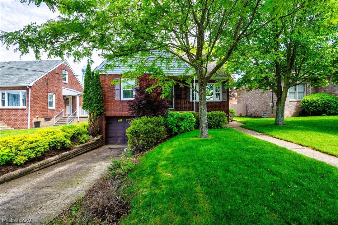 OPEN HOUSE HELD ON MAY 20 WEDNESDAY 430P-630P!  Home That Checks Every Box — Charm, Space, and Convenience!  From the moment you arrive, you’ll appreciate the care and attention that has gone into preserving and updating the property over the years!  This Marland Heights Brick beauty is full of warmth, character, and functional living space! Step inside to a welcoming living area highlighted by a recessed electric fireplace, creating the perfect cozy atmosphere for relaxing or entertaining. The main level features a spacious bedroom complete with its own recessed electric fireplace and a full bath, offering convenience and comfort for guests or main-floor living.  The updated, fully equipped kitchen is ready for everyday meals or holiday gatherings and flows nicely into the formal dining room. Much of the first floor showcases beautiful hardwood flooring, adding timeless appeal throughout the home.  Upstairs, you’ll find two additional bedrooms along with another full bath, providing plenty of space for family or visitors. The basement offers abundant storage space and could easily be transformed into a den, recreation room, home gym, or hobby area.  Car enthusiasts and outdoor lovers will appreciate the attached garage with ample room for a boat, seasonal toys, or extra storage, along with a detached 2-car garage that adds even more convenience for parking, projects, or easy grocery unloading. This well-maintained home blends classic charm with practical updates and versatile space inside and out!  From this home you can be in Ohio or PA in approximately 15 min!  ALL PER SELLER AND APPROX: WINDOWS MAY HAVE A TRANSFERRABLE WARRANTY AND WERE INSTALLED 2021 AND 2023 .