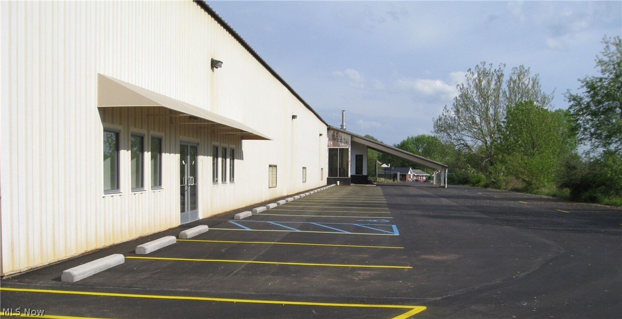 29,841 sq. ft. building on 3.4 acres.   27,600 on the main floor with a 2,241 sq ft mezzanine.  The building is 20  foot tall with a 39 foot peek, open span building. Was used for 4,    6,000 sq ft tennis courts.   There are still 3 courts and the 4th has been petitioned off for a retail shop.  Has built in shelves, multiply bathrooms.   Kitchen.   The loft consists of a fully equipped training center with high-quality weight machines and weights.  Also consists of offices for judging for sports events.
