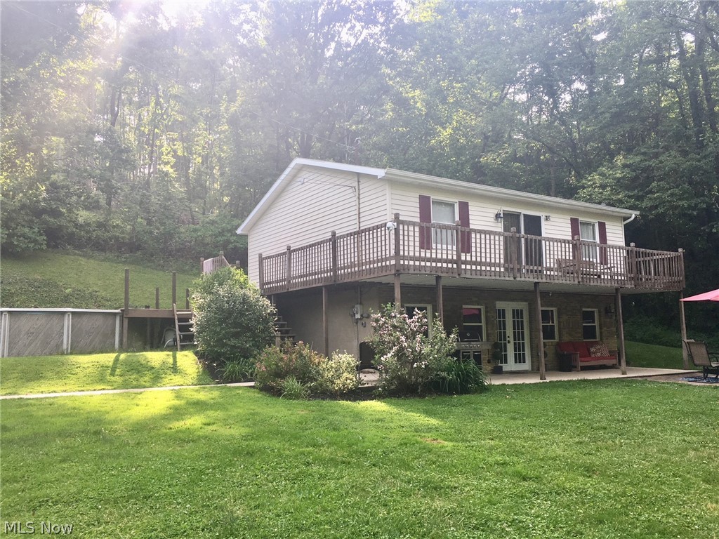 What a rare find! This is only the second time this home has ever been on the market. Located on a dead end with nearly 10 acres, you will find this mechanic and hunters’ dream home. Want that country feel and seclusion without sacrificing city utilities? You got it! This home has city water and sewer, natural gas, and cable high speed internet capabilities. This 3 bed 2 bath home features a recently remodeled kitchen, dining room, and living room, including a natural gas fireplace. A laundry room and full bathroom on the first floor is an amenity all can appreciate. A beautiful spiral staircase leads upstairs to a spacious master bedroom, two additional bedrooms, an office, and another full bath. Outside, a ¾ wrap-around deck opens to the 21 ft round above ground pool you’ll be sure to enjoy on hot summer days. The furnace and central air units were replaced in 2015 and the water heater was replaced in May 2020. New gutters, spouting, and gutter guard installed on the home and garage in 2016 make cleaning the gutters a thing of the past. New flooring throughout and lighting upgrades in 2018 make this home truly move-in ready.
The 2400 sq ft concrete block garage features 13-foot ceilings, a car lift, industrial air compressor, and a finished “man cave.” Upgrades include all new lighting, two ceiling fans, new ceiling insulation, and a new natural gas heater. You must see to appreciate everything this property has to offer! This one won’t last long! Agent owned