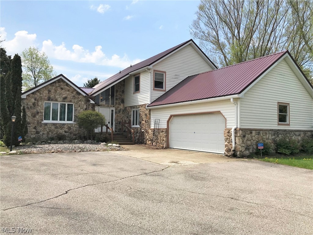 Spacious contemporary styled colonial set on a nearly 2 acre lot. Featuring an open kitchen/family room area with gas fireplace, 1st floor laundry, XL living room with sliding glass door to a huge deck, private back yard and above ground pool. New flooring throughout most of the home in May 2019. Newly waterproofed basement in July 2019. Master bedroom, master bath, central air, walk-out basement into the 2 car attached garage. Florida room, additional storage shed and located across the street from Lake Erie!