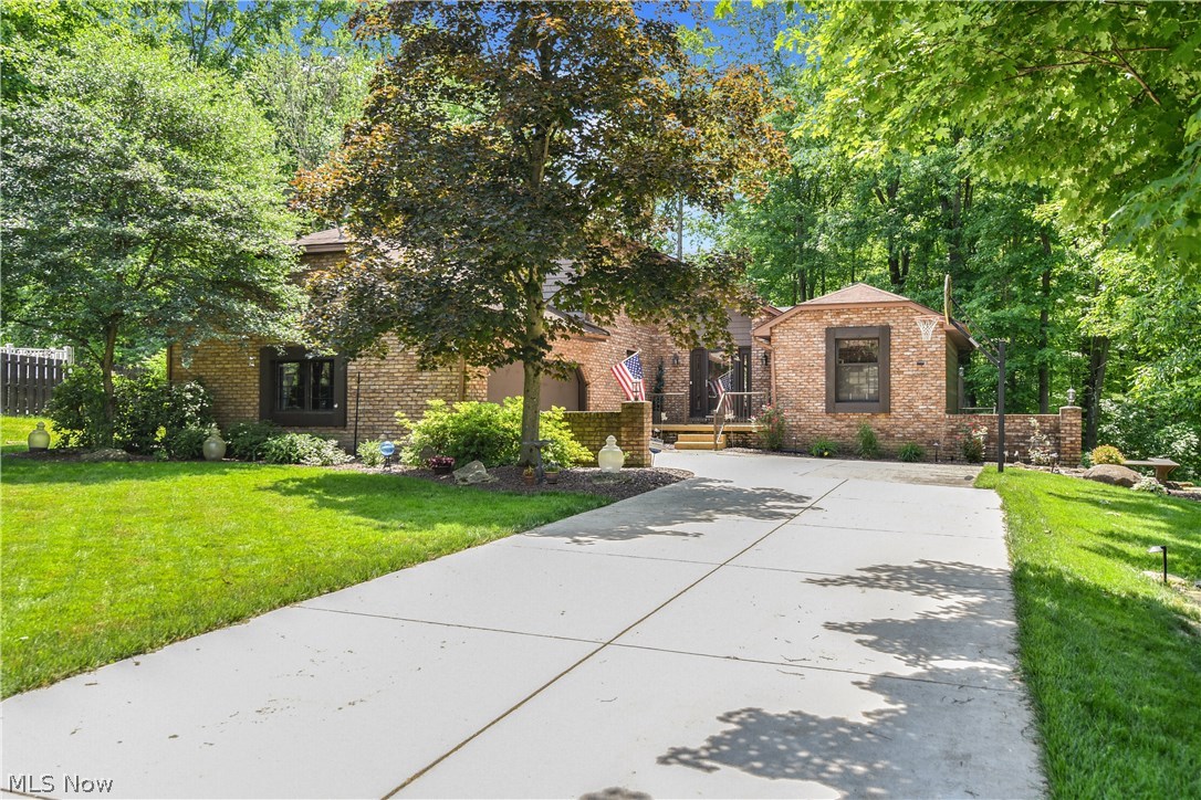 Gorgeous home located in one of Austintown’s most serene and desirable neighborhoods. This home boasts over 2600 square feet (not including basement) and offers 3 bedrooms and 4 bathrooms. The 2 story foyer showcases a wall of windows allowing for tons of natural sun light. Updated kitchen includes a center island, corian countertops , wood flooring and stainless steel appliances. The kitchen opens to a sunroom with 20 foot ceilings and also opens to the large family room with gas fireplace and built-ins.  Sliders off the family room give you access to the multi- tiered deck. The living room has detailed wall and ceiling paneling plus a built-in bar/entertainment area. The first floor is completed with a dining room, laundry room and a ½ bathroom.  Your master suite is spacious and offers a walk-in closet, dressing area and full bathroom. Two additional bedrooms and full bath complete the 2nd floor. You are going to love this basement that has been partially finished with nature stone
