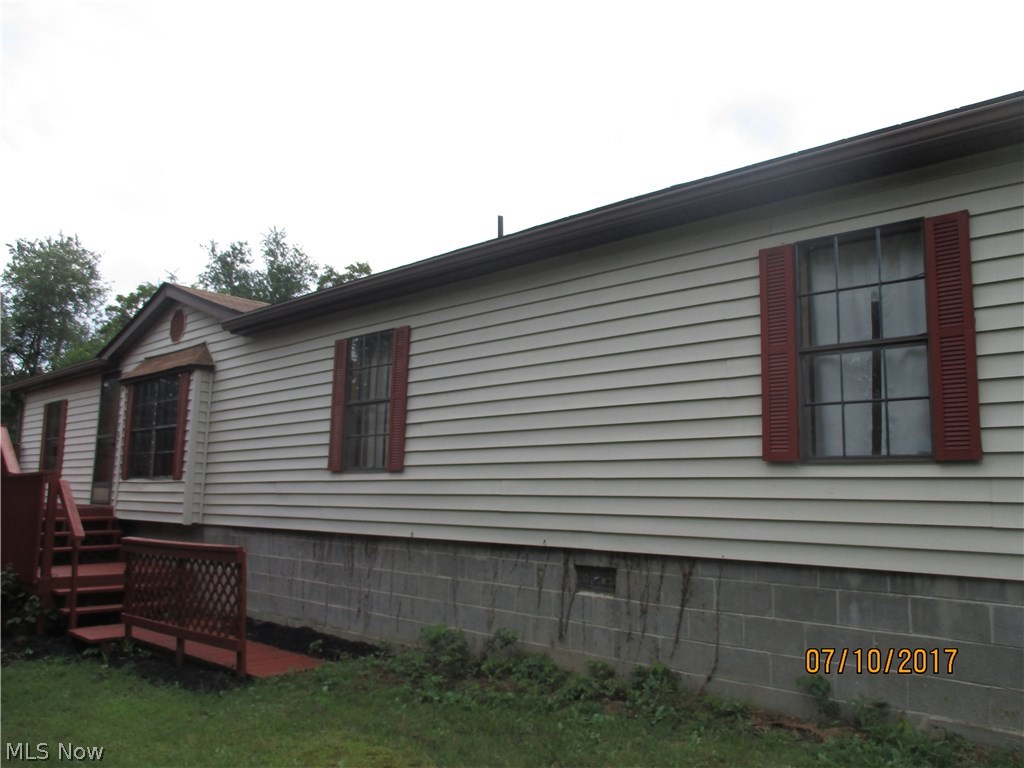 This 1560 sqft manufactured home boasts a spacious living room opening into a great room with built in bookshelves and tv area.  Large kitchen/dining area with island/serving area between  kitchen and living room. Cathedral ceilings add to  the open look.  Master bedroom with built in storage cabinets, master bath has separate  dressing area and walk in closet.  New flooring, plumbing, and 200 amp service.  All this plus 1.23 wooded acres.  Move in now !!!