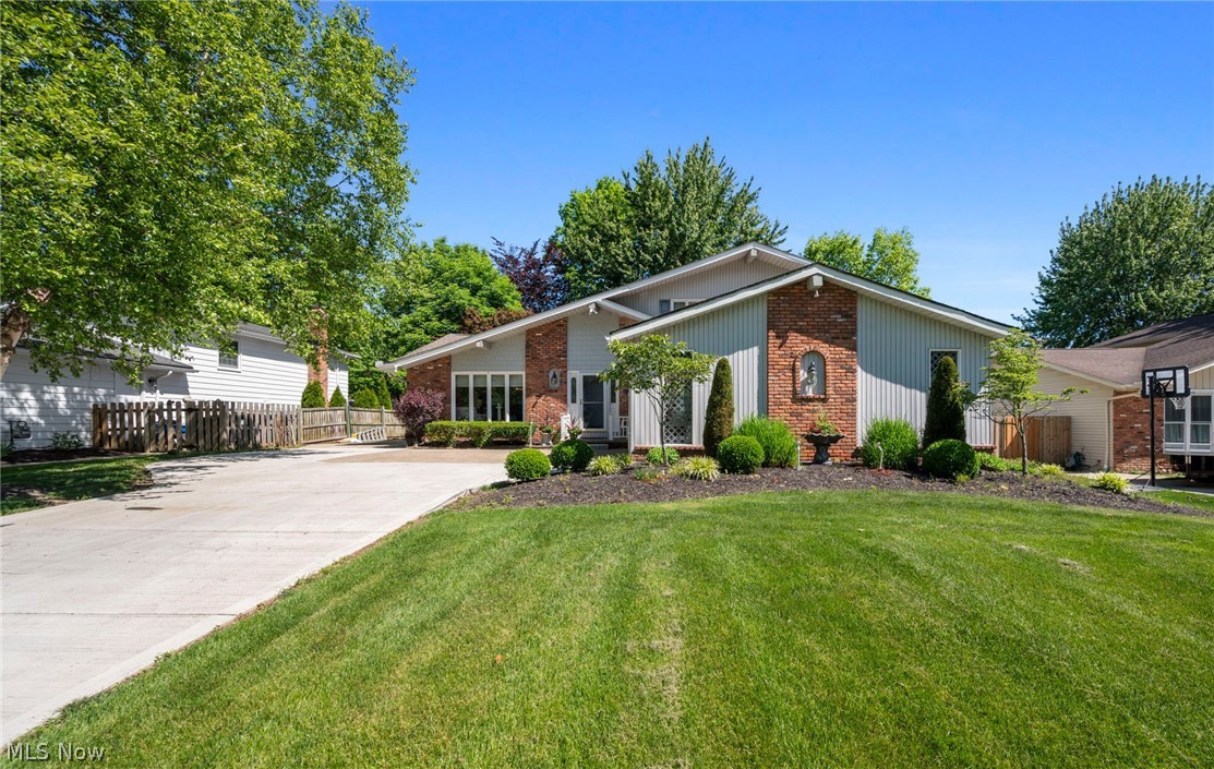 Absolutely gorgeous one-owner home that has been meticulously maintained and thoughtfully updated throughout! The floor plan and finishes have been enhanced over time to keep the home fresh, modern, and stylish, showcasing quality and craftsmanship at every turn. The expanded, fully remodeled kitchen is a standout feature, complete with custom cabinetry, granite countertops, a large center island, built in bar area, recessed lighting and brand-new stainless appliances - perfect for both everyday living and entertaining! The living and dining rooms impress with soaring ceilings and beautiful cherry hardwood floors. The inviting family room features a full stone fireplace and sliding doors that open to a patio and private backyard creating seamless indoor-outdoor living! The main level also includes a bedroom, half bath and home office offering flexibility for guests and remote work. Upstairs you will find three additional bedrooms, including a spacious master suite with updated master bath and an updated guest bath. The lower level was just finished prior to listing and offers many uses! Brand new driveway with extension, newer roof and excellent curb appeal! Great development with 2 swimming pools, parks, and playground!  This home has it all! Move in and enjoy!