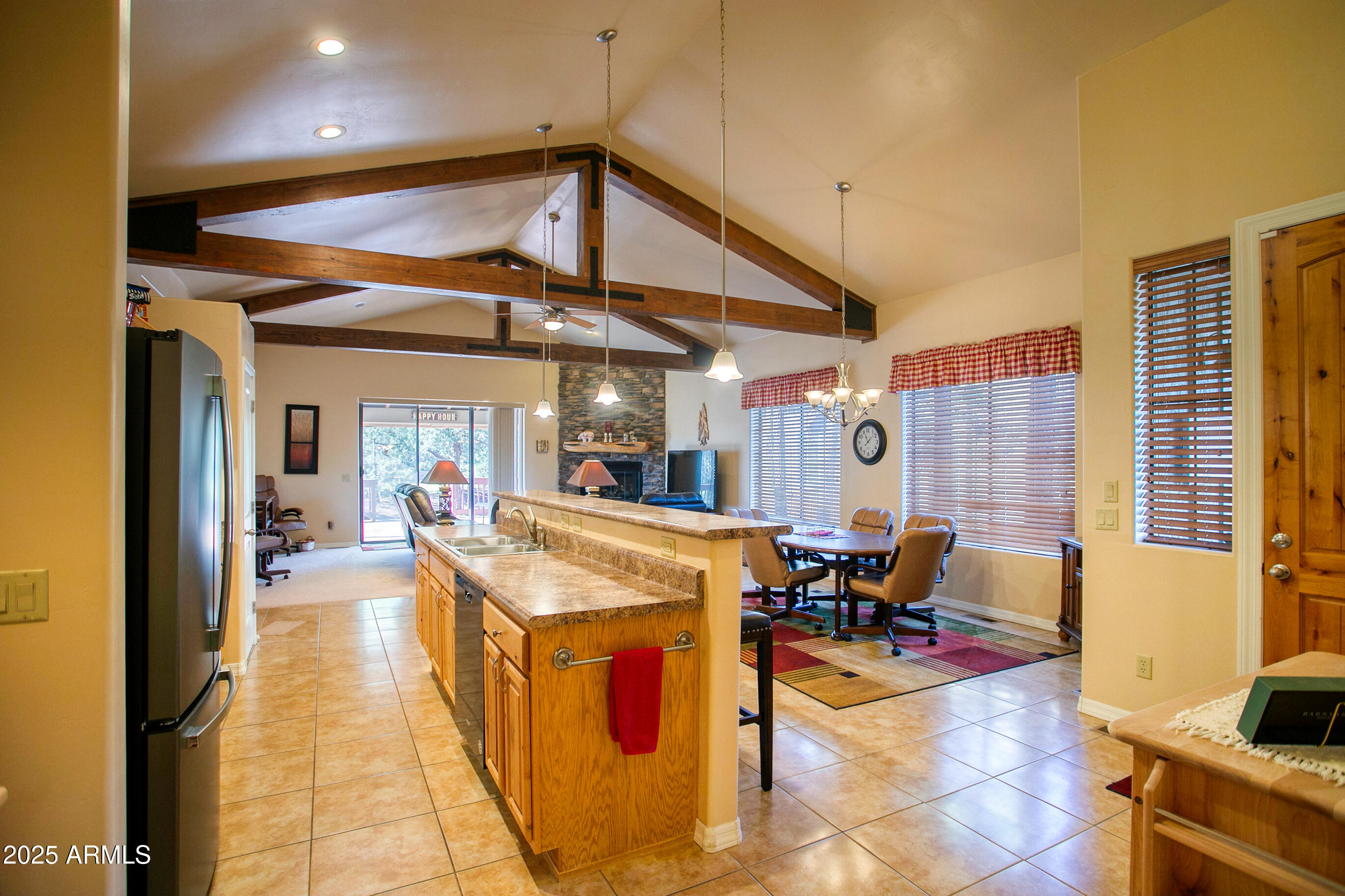 Beautifully maintained single-level townhome in the gated Mountain Gate community of Lakeside. This fully furnished 3-bedroom, 2-bath home features an open floor plan with exposed beams, a stone gas fireplace, and a split-bedroom layout. The spacious primary suite offers a large walk-in closet. Sliding glass doors open to an oversized back deck surrounded by mature trees, perfect for relaxing, entertaining, or enjoying wildlife. Additional features include a 2-car garage, paver driveway, stone accents, and a retractable awning. HOA covers exterior maintenance, snow removal, garbage, landscaping, private streets, and gated entry. Conveniently located near shopping, dining, lakes, hiking, casino, and Sunrise Ski Resort.