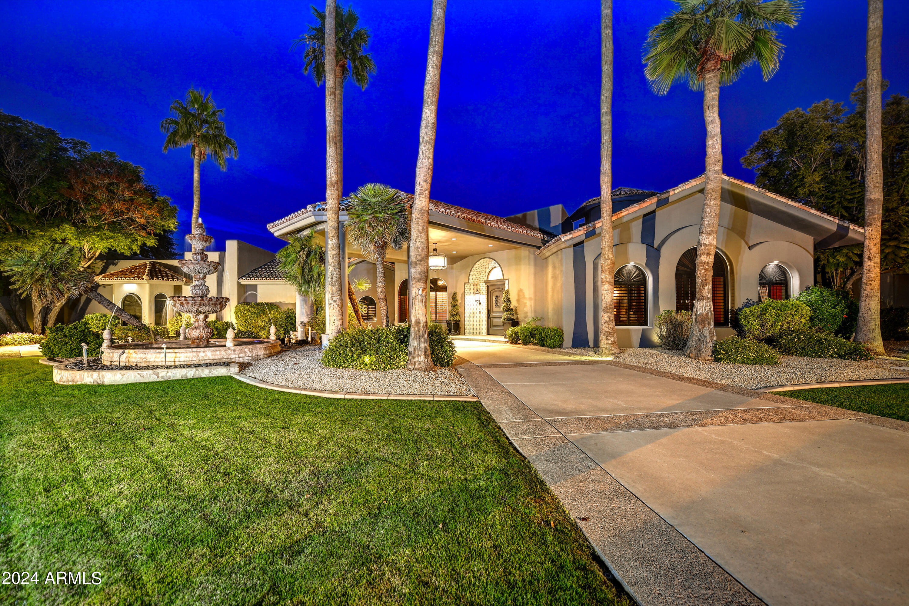 This gorgeous Paradise Valley home has been meticulously maintained and thoughtfully updated to maximize the space for family, friends, entertaining and comfort. The circular driveway with a porte a cochere welcomes you into the gracious home. A cozy family room with a custom brick fireplace and soaring ceilings is the heart of the home and the kitchen features new Sub Zero and Wolf appliances with custom features throughout. An atrium off of the family room offers a cozy outdoor sanctuary with a natural stone paver and turf checkerboard floor with a soothing water feature. Memories will be made in the theatre/game room and off the entry an office with built-ins is a perfect quiet place to work. The extra large custom pantry is what dreams are made of with plenty of storage space, two full sized wine refrigerators and an additional space for a full size refrigerator. The oversized laundry room features two sets of washer and dryers with a dog bathing area, separate farmhouse sink, multiple racks to hang clothing and plenty of counter space.  The owner's suite on the first floor is a true respite with a gorgeous brick fireplace and feature wall with wood beams and custom built-ins. Two additional bedrooms on the first floor are both ensuite. 



Upstairs two bedrooms share a large bathroom and charming loft overlooking the family room.The backyard is an entertainer's dream with a huge covered patio, outdoor kitchen, fireplace, gorgeous heated pool and spa with water feature, lush landscaping, citrus trees, new irrigation and huge grassy area. 
To complete this fantastic property, the solar is owned.