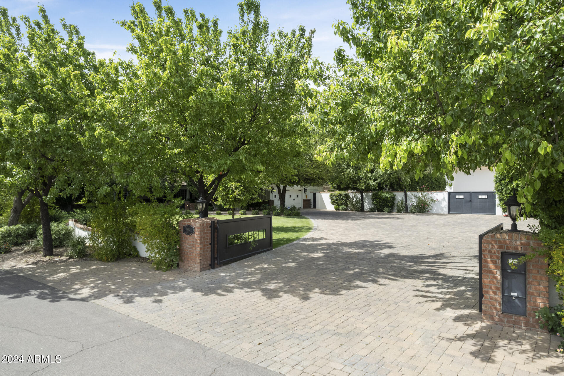 Presenting an unparalleled residence in the highly sought-after Cactus Corridor. This ranch-style sanctuary, enveloped by over an acre of private and meticulously curated landscaping, promises an unmatched living experience. This genuine masterpiece features the main home with 4662sqft, 4 beds, 5 baths, separate office, den, a detached 1140sqft guest casita and an oversized RV garage. The exterior alone solidifies this property in a league of its own, standing as a testament to its timeless design that you truly must see in person to understand. Artfully crafted hardscapes and landscaping transport you to a private, garden-like living experience. Thoughtfully designed private outdoor patios surround the residence and create one of the most private and functional homes in the Valley. Step inside to discover a realm of exquisite craftsmanship and meticulous details - from the refinished hardwood floors to the high-end custom woodwork that grace every door and window in the home. Four generously sized bedrooms, each with a walk-in closet (3 en-suites). The oversized master suite offers sweeping views of the lush yard and a private patio adorned with a fire pit. In addition, a flex space could easily be turned into a cozy den or a playroom. A full office features custom built-ins, and seamless backyard access, creating an inspiring at-home workspace. The property boasts an expansive 16-car, temperature-controlled RV garage, a paradise for car enthusiasts. With 18-foot ceilings, a built-in tool shop, air compressors, and custom storage, it caters to every automotive need. Home also has electric car charging station, 2 additional bespoke detached garages (total 3 separate garage buildings), and a grand RV gate contribute to the property's functionality and attention to detail. The detached casita is a haven of its own, featuring it's own kitchen, living space, bath, spacious bedroom with washer/dryer hookups, walk-in storage closet and awe-inspiring backyard views and patio space. Step into the backyard retreat with sprawling lawns, a beautifully designed, water and fire features, and an 85" outdoor TV. Gas fire pits and a full-size basketball/pickleball court, illuminated by industrial lights, complete this entertainer's dream backyard space. This residence is not merely a home; it's an extraordinary living experience of charm and functionality unlike anything else. Don't miss the opportunity to experience this home in-person.
