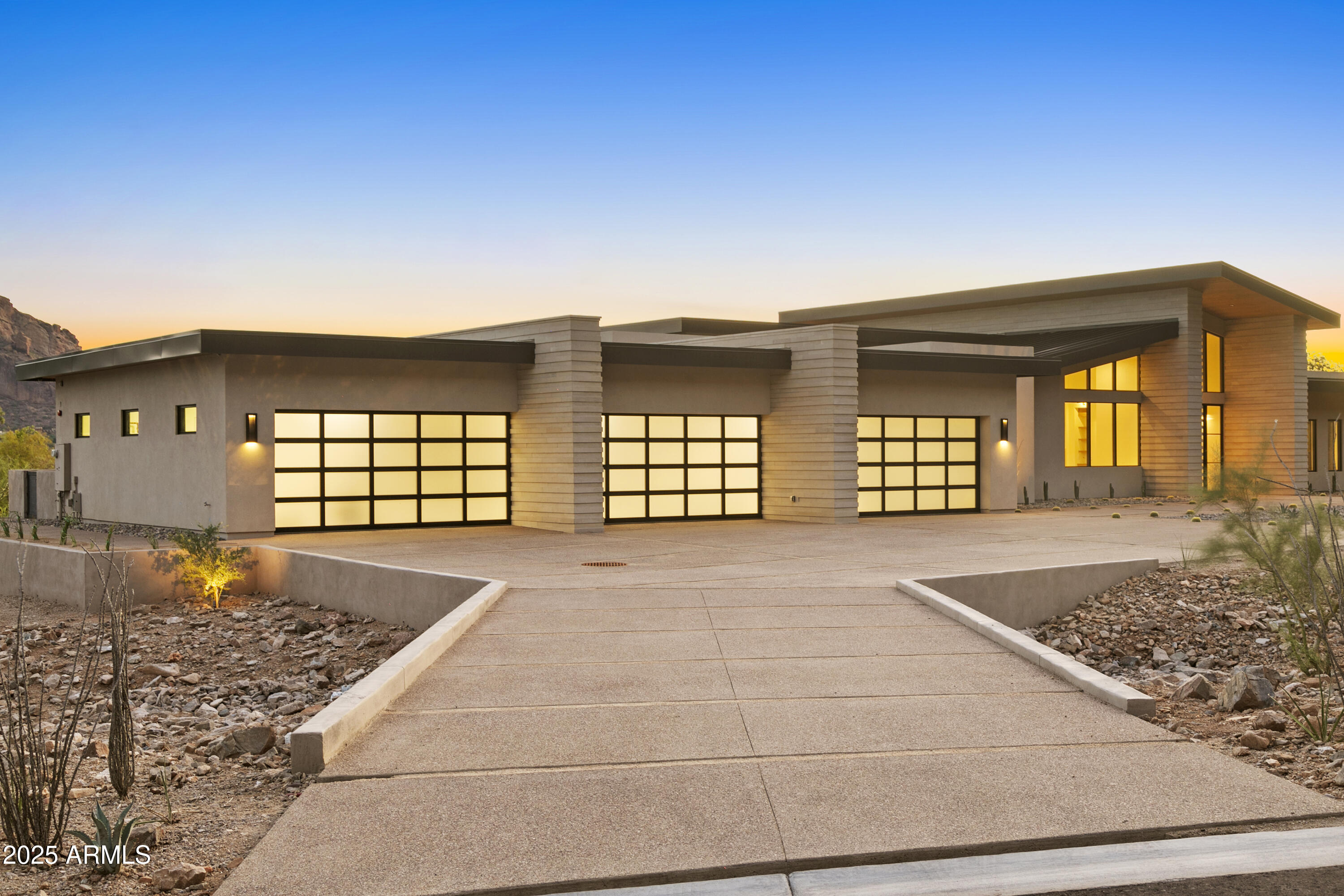 Perched atop Mummy Mountain with iconic Camelback Mountain head-to-tail views, this contemporary estate blends dramatic architecture with seamless indoor-outdoor living. A light-filled interior features soaring ceilings, walls of glass, a chef's kitchen with butler's pantry, and a stunning glass-enclosed wine room off the dining area. The master suite wing features a gigantic bedroom, spa-inspired bath with indoor and outdoor showers, massive walk-in closet and separate office with pool bath. A game room with full bar opens to the resort-style backyard with pool, spa, outdoor kitchen, firepit, and multiple patio areas. Six-car garage, smart-home features, and countless carefully curated designer details and features complete this modern masterpiece.