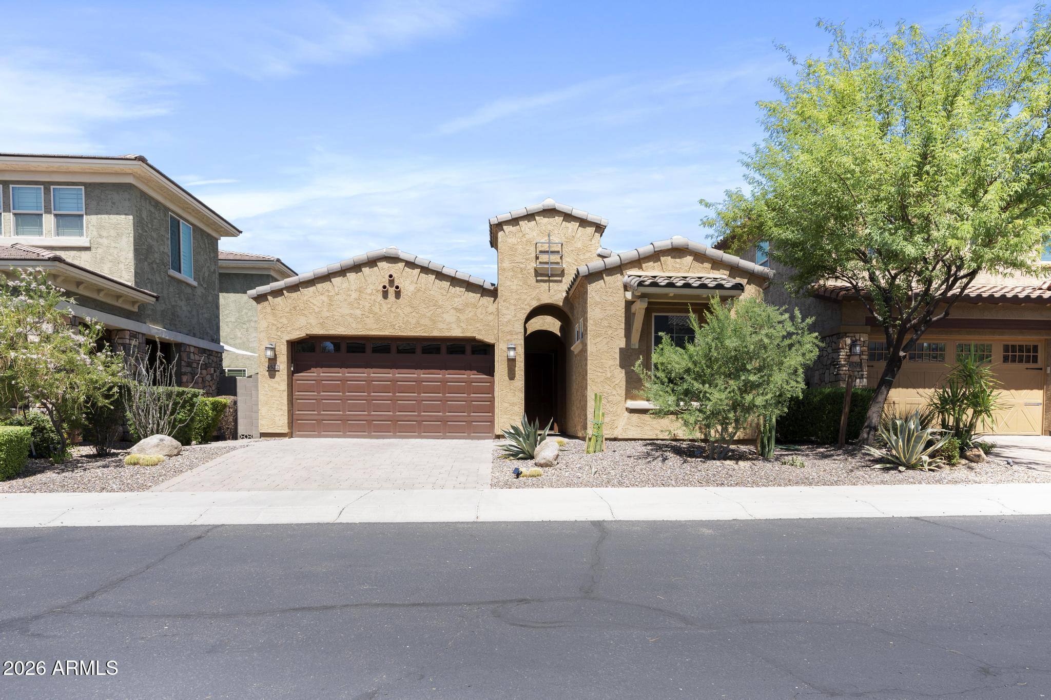 Highly upgraded and impeccably designed, this stunning home is situated on a premium interior cul-de-sac lot across from the park in one of Desert Ridge's few gated communities. Elegant marble flooring flows throughout the open-concept floor plan, complemented by soaring ceilings, designer lighting, and thoughtfully selected high-end finishes. The gourmet kitchen is a true showpiece, featuring Monogram stainless steel appliances, a gas cooktop, oversized island with pendant lighting, upgraded electrical and recessed lighting, reverse osmosis system, walk-in pantry, and premium cabinetry with soft-close drawers, crown molding & glass display cabinets.
The luxurious primary suite offers a spa-inspired retreat with an oversized walk-in shower featuring a bench, floor-to-ceiling tile & glass surround, dual vanities with designer sconces flanking custom mirrors, and an expansive walk-in closet with custom built-ins. Step outside to a private backyard oasis featuring a covered patio, low-maintenance turf, and raised desert landscaping planters, a spa, outdoor kitchen and a stunning glass gas fireplace for relaxing or entertaining. Other custom features include roller shades, soft water system, upgraded interior doors, garage floor epoxy, garage overhead cabinets, just to name a few. 
Residents also enjoy exclusive access to resort-style community pools and amenities. With plenty of open space, a playground, ramadas with picnic tables and BBQ's, sidewalks and trails throughout, this is the ideal setting to call home. Sanctuary at Desert Ridge features an approximate 3,600 square foot Clubhouse and includes, but is not limited to, a multi-purpose room with a catering kitchen, indoor/outdoor fireplace, exercise area, pool, lounge areas, outdoor fire pit, BBQ area, seating, and shade structures, along with convenient parking area. This highly sought-after location is located within a highly acclaimed school district and just minutes away from shopping and dining at Desert Ridge Marketplace, City North and Kierland Commons. The community is located off of Tatum Boulevard and Pinnacle Peak Road, conveniently located near Loop 101 and offers quick access to major employment centers in Scottsdale and Deer Valley.