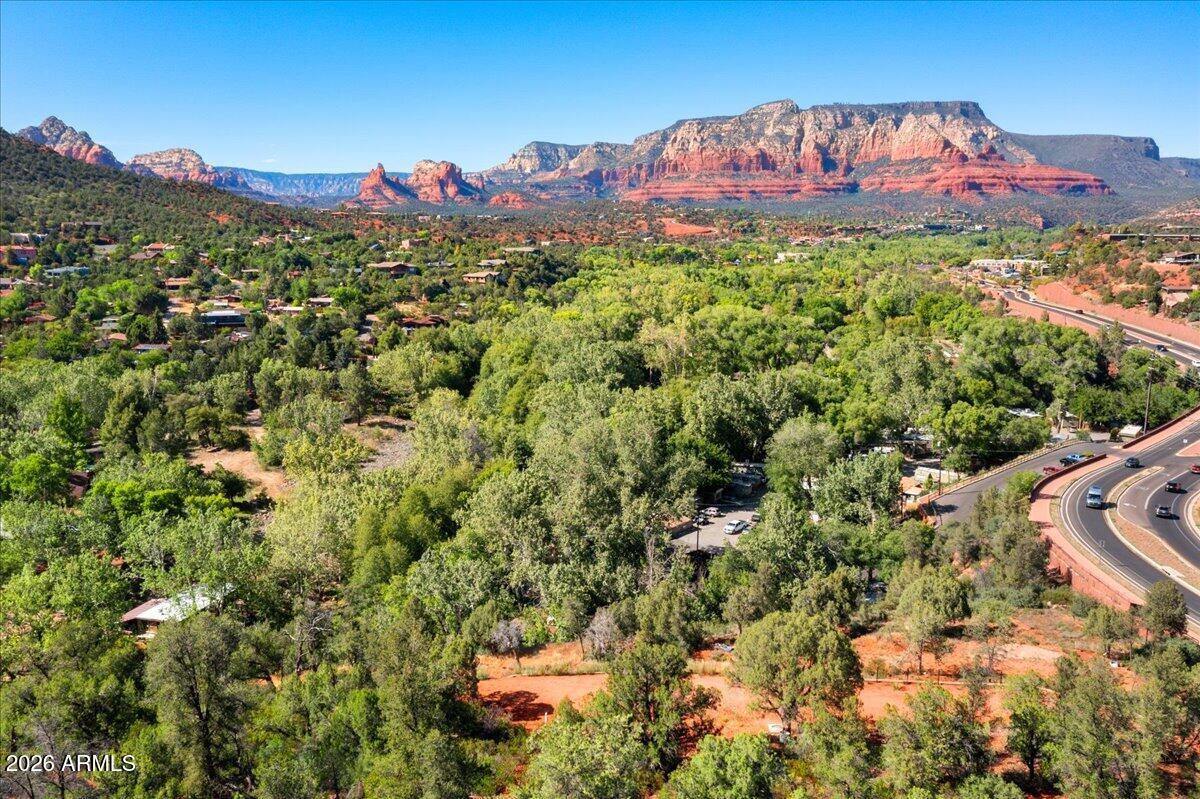 Beautiful homesite in the heart of Sedona, offering wide-open, unobstructed views of the iconic Red Rock formations. This is a rare opportunity to own property in one of Sedona's most breathtaking natural settings.  NO HOA restrictions.  Short term rentals may be allowed with proper City permitting.  The seller has completed significant groundwork, including bringing utilities to the lot, cutting in the road, preparing house plans, and completing a geotechnical soil test. Permits are ready for pickup, helping streamline the building process.  The property offers peaceful surroundings, incredible sunsets, and the soothing sound of a nearby creek--enhancing the calm, quiet atmosphere that makes Sedona so special.  Ideally located near Sedona's restaurants, galleries, hiking trails, and outdoor recreation, while still providing privacy and space to unwind.  Opportunities like this--combining views, privacy, and a prime location--are becoming increasingly rare. Come experience it for yourself.