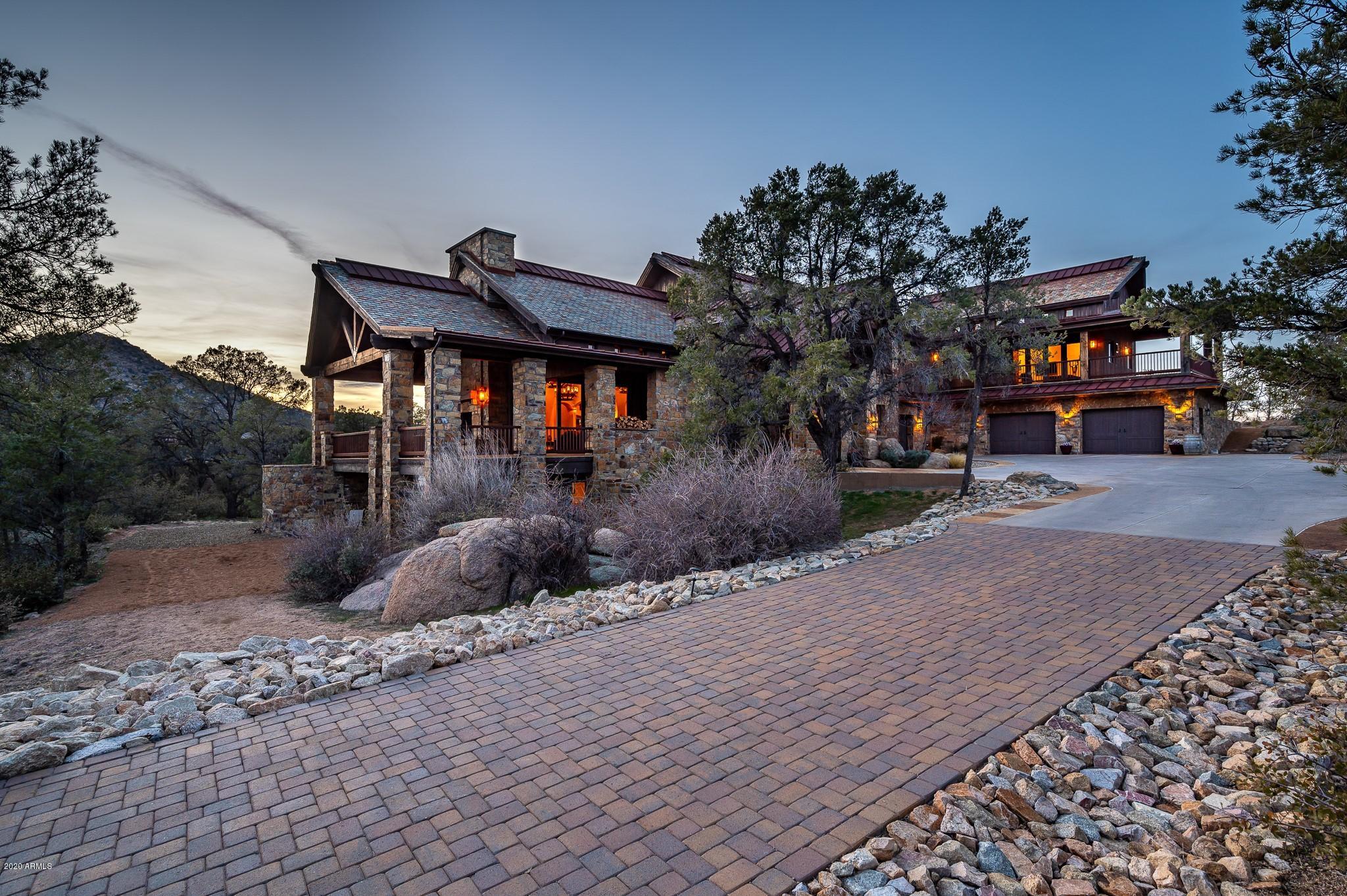 Exquisite Custom Estate designed with superb craftsmanship! This gorgeous home, near the base of Granite Mountain, is luxury living at its finest with over 10,000 SF, stunning beamed ceilings, copper touches and hand laid stone throughout. Each living space showcases the love of the outdoors from picturesque views and the disappearing sliding doors to the wrap around decks, the outdoor living blends perfectly with indoor comforts. The chef's kitchen boasts two large islands, a Wolf stove with 2 ovens, sub-zero refrigerator and freezer, dual dishwashers, and much more. The master suite features a sitting area, expansive bathroom with jetted tub and dual, height varied vanities, and two beautifully appointed master closets. Upstairs features a family room and a game room/man cave, (cont.) as well as a second master bedroom complete with bathroom and laundry. Downstairs adds three additional master bedrooms as well as an additional family room. 3-car attached garage as well as an over-sized RV Barn, complete with hookups, makes this a car-lover, toy-lover's dream.  There is so much to see in this beautiful home. Call to schedule an appointment today.