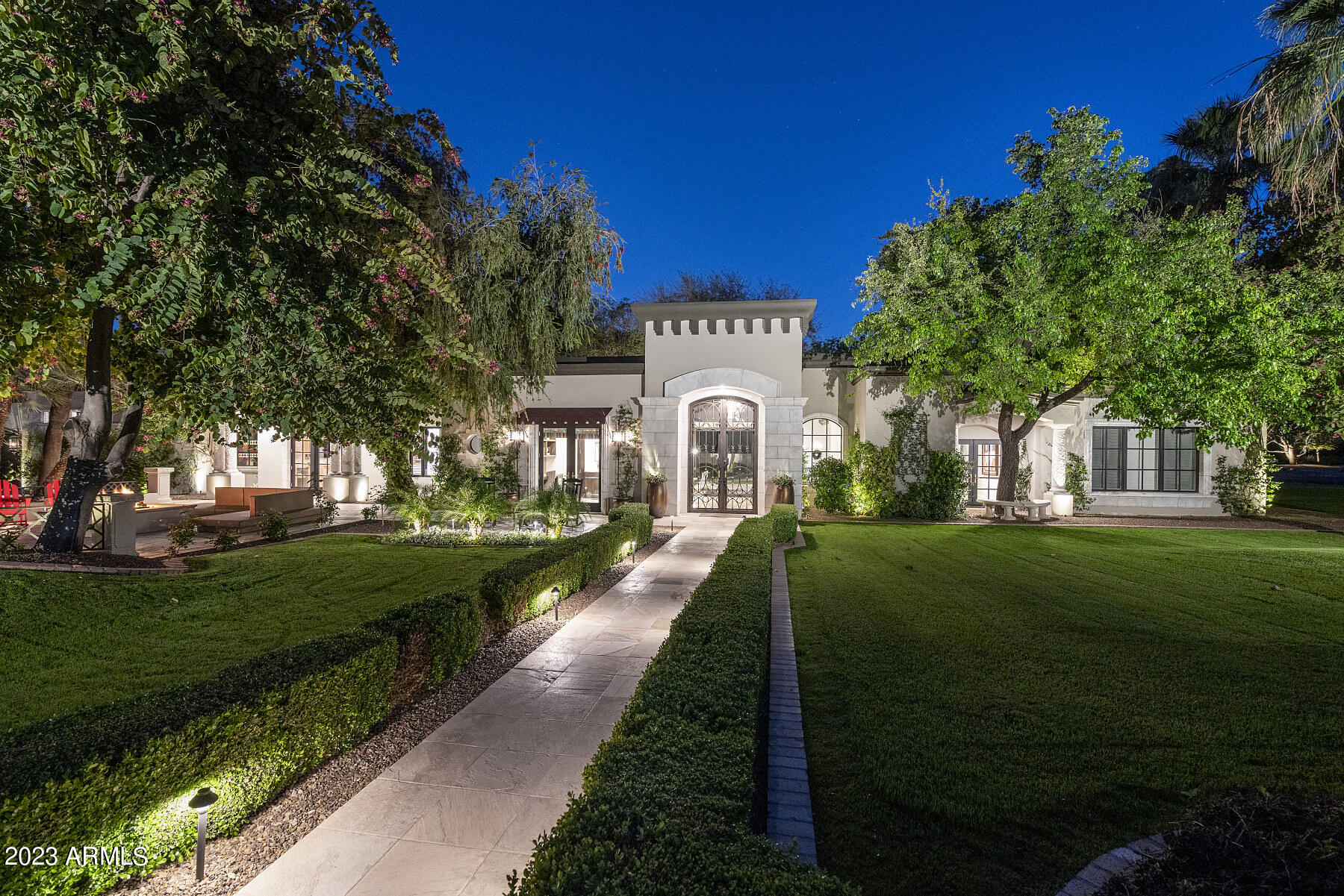 Don't miss your chance to own this stunning property in one of Paradise Valley's most sought-after neighborhoods. At over 8,000 sq ft and originally designed by Kelly Wearstler, this home is perfect for entertaining a crowd or for a cozy night in. With the luxury of indoor-outdoor living through two sets of nano doors, this home is perfect for everyone. Pull your favorite bottle from your custom wine cellar and enjoy with friends or family around the pool, spa, bocce court or fire pit, or stay inside and cozy up in the state-of-the-art theater. At less than $725 per square foot this home is competitively priced, particularly for this neighborhood, while still sitting atop of one of the best and largest interior lots. Come and make this home your own by transforming the secondary yard into a pickle ball court, half basketball court, water feature, or whatever your heart desires!