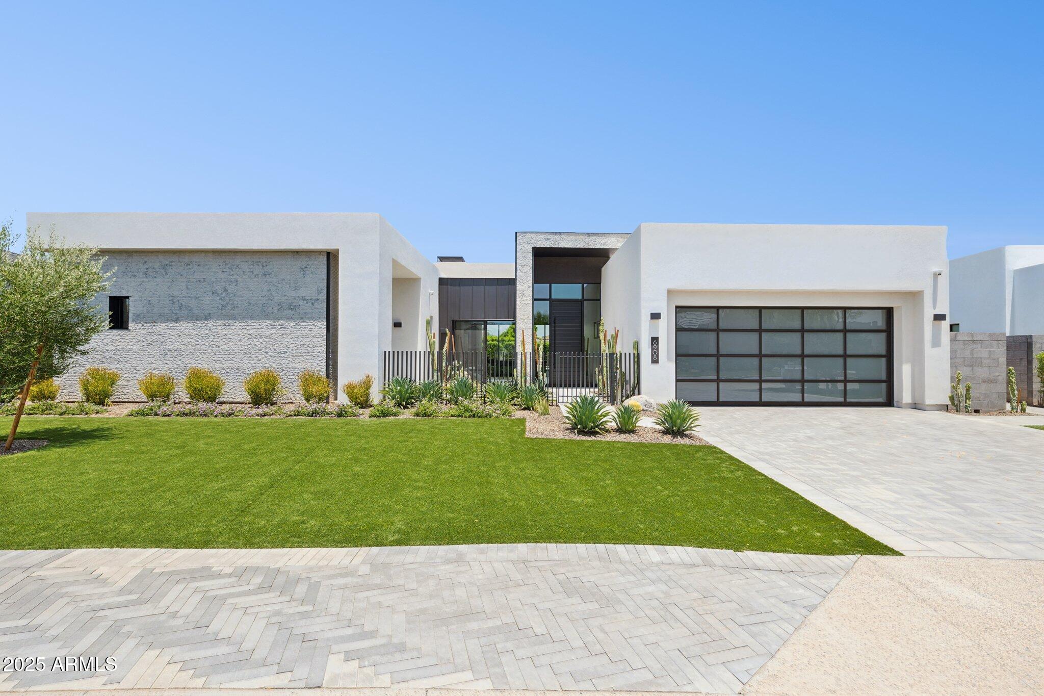 BRAND NEW HOME AT THE RITZ CARLTON LOCATION...NEVER LIVED IN...Discover an  exquisite, contemporary masterpiece in the most desirable location.  Its an open floor plan with tall ceilings, 3 bedrooms and a den.  This home has a state of the art kitchen with top of the line Appliances, wine towers and a back kitchen to include the extra fridge, dishwasher, sink.  The FR/DR doors recede to make any party successful with the heated patio overlooking the negative edge heated pool and spa. Sit and enjoy the Ramada with the Wolf BBQ and a floating fireplace.  Indulge yourself in the master bath with a steam shower,  dual shower heads, lit closet cabinets with pull downs for extra storage.  Garage is Air conditioned and insurated. has automated window shades. Many upgrades.  Come visit...