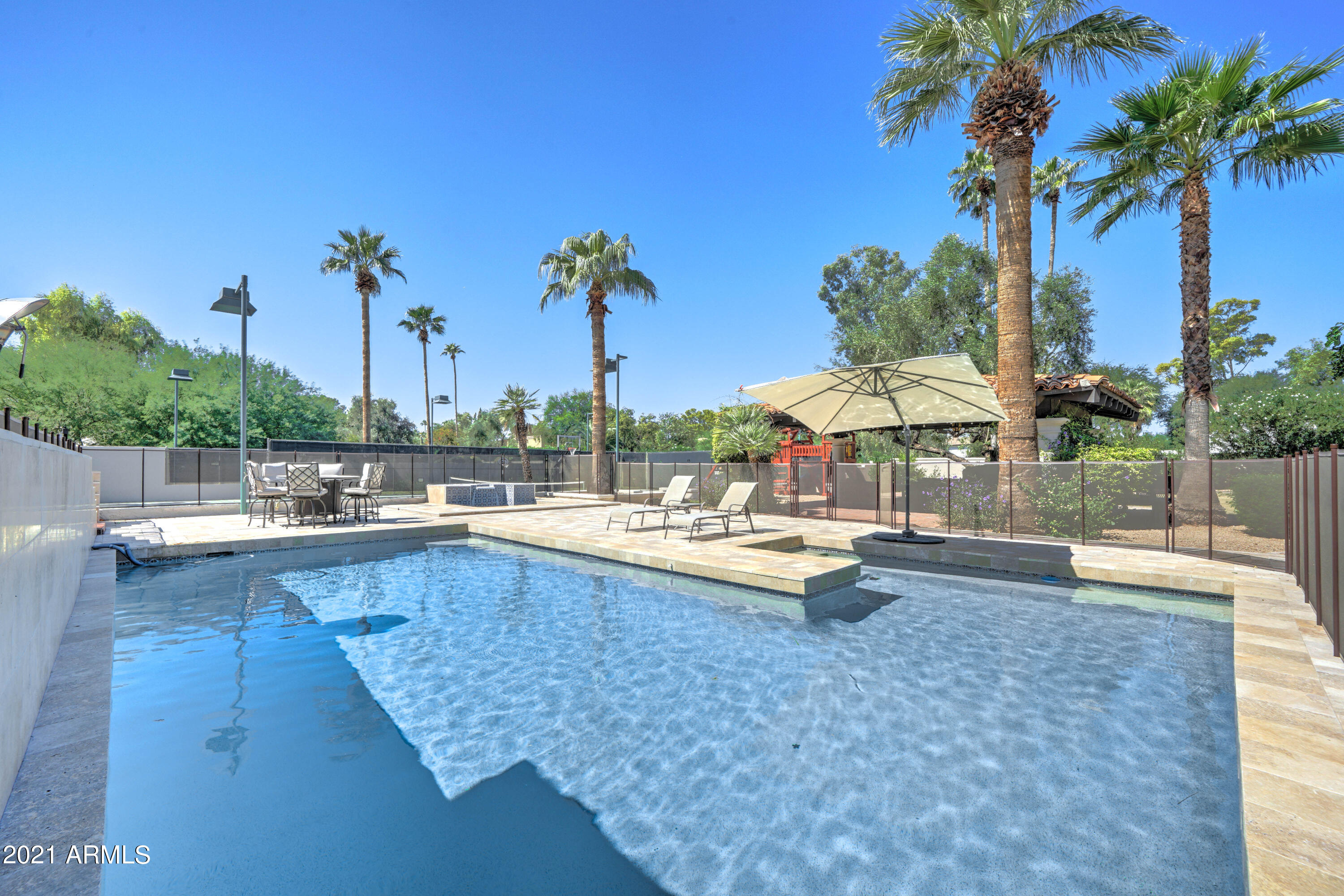 Total remodel on this fabulous estate home featuring a sep. 1200 SF guest home & full sized tennis court in the highly desired Camelback Country Club Estates enclave! This gorgeous property features sophisticated living spaces with hand carved hickory wood flooring, soaring high wood beamed ceilings, an over the top chef's kitchen w/ 2 lg. islands, a spacious breakfast nook area,  a huge great room ----all over looking the resort style backyard!  This sensational chef's kitchen features 2 islands, 2 dishwashers, 2 sinks, 2 ovens & all new white quartz countertops! The new owner will delight in the decadent master bedroom suite  that features soaring high vaulted wood beamed ceilings, a fabulous marble & wood detailed floor.  The totally remodeled master bathroom features all new custom cabinets, white quartz countertops, designer lighting & plumbing fixtures...& a fabulous shower & sep. claw-footed soak tub!  Huge master walk-in closet is a dream come true!  The A+++ resort style backyard boasts a sensational pebble-tech pool & sep. spa + a pool-side ramada, a full size tennis court & a huge grassy play area! Split floor plan features 3 secondary bedrooms & an office.  This home also features a flex room that is being used as a exercise room.  Not to be overlooked is the sep. guest house that features soaring high wood beamed vaulted ceilings, a huge great room, kitchen, full master bedroom/& full bathroom & laundry cntr.  (More pictures of the entire property coming in the next 2 weeks--this is a 'sneak peak' only with current pictures)