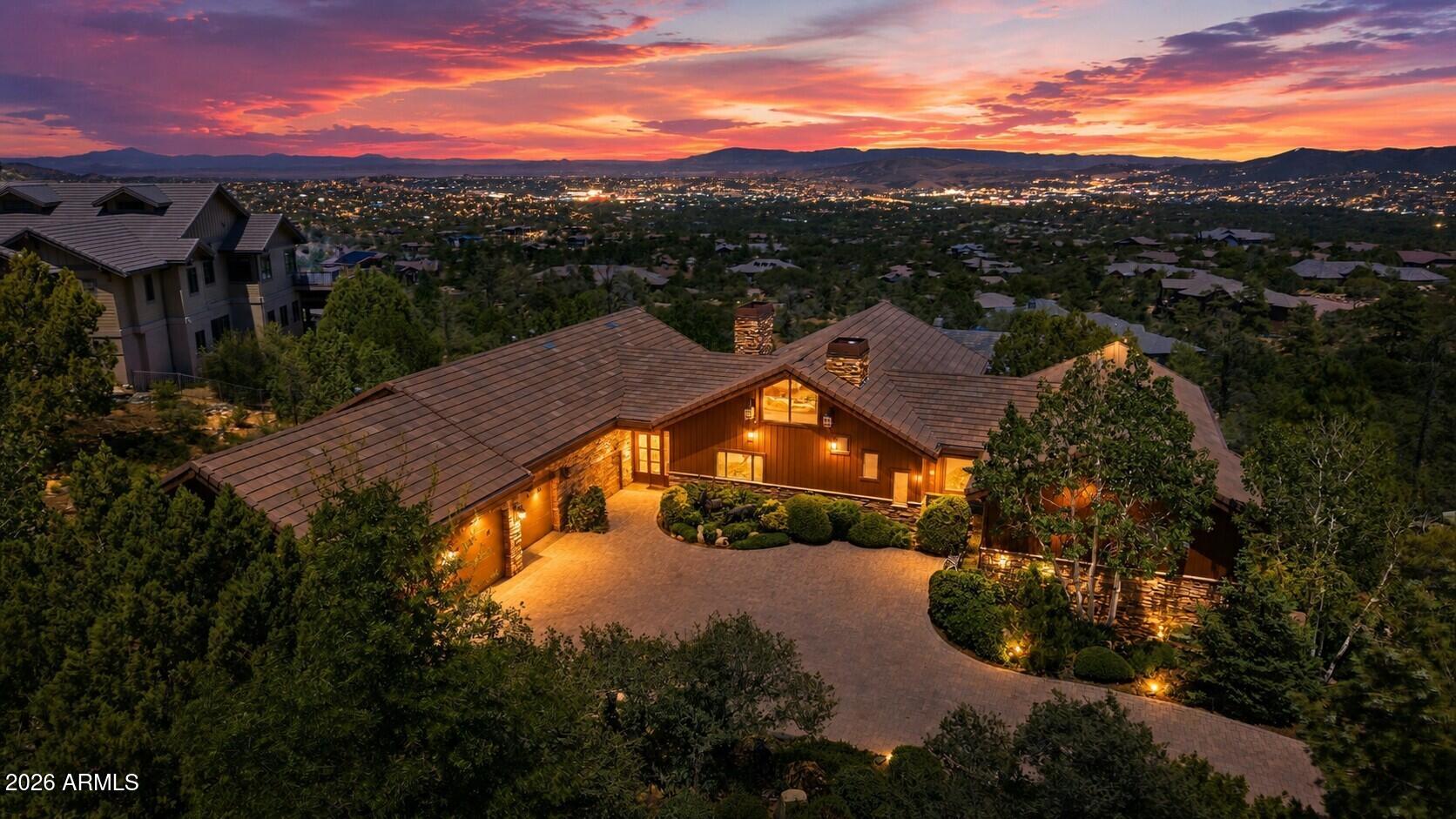 Perched on nearly an acre in the prestigious gated community of Forest Ridge at Hassayampa, this extraordinary 5,785 square foot luxury estate captures breathtaking panoramic views stretching across the towering Ponderosa pines and the surrounding mountains beyond. Designed for both elegant everyday living and exceptional entertaining, this custom home offers a seamless blend of timeless craftsmanship and modern updates.
Step inside to discover brand-new European white oak hardwood flooring, soaring ceilings, and walls of windows that perfectly frame the spectacular scenery. The impressive great room is anchored by a stunning stacked stone fireplace, creating a warm yet sophisticated gathering space that flows effortlessly into the gourmet kitchen.

The luxurious primary suite is a true private retreat, featuring separate his-and-her walk-in closets and an exceptionally appointed bath with individual water closets for the ultimate in comfort and privacy.

Downstairs, entertainment takes center stage with a spacious game room, full wet bar, and a versatile bonus room ideal for a private theater, fitness studio, or additional guest accommodations. Whether hosting family celebrations or intimate evenings with friends, this home was built to impress.

Additional highlights include a spacious three-car garage with abundant storage, beautifully landscaped grounds, and multiple outdoor living spaces where you can relax and take in Arizona's unforgettable sunsets.

Offering an unmatched combination of luxury, privacy, and spectacular views, this remarkable Forest Ridge residence is a rare opportunity to own one of Prescott's premier homes.