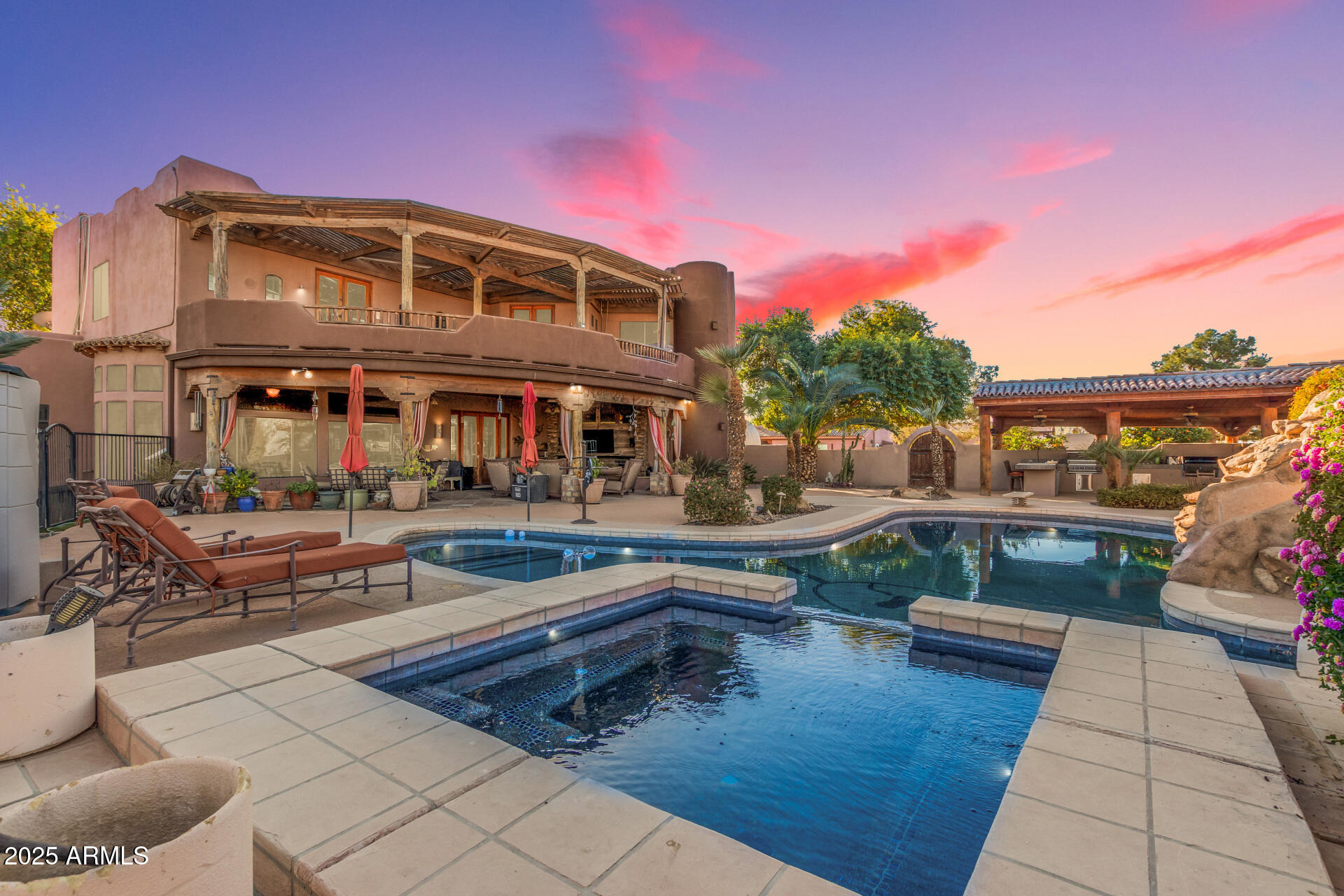 Welcome to this extraordinary equestrian estate in Gilbert, AZ! Spanning over 5.1 acres, this property is a horse lover's paradise with 15 covered stalls, 2 AC tack rooms, a lighted roping arena, and multiple grass pastures with a sprinkler system. It includes a private well for irrigation, solar, and city water.

The custom home, built in 2000, offers 4,908 sqft of luxurious living with 5 bedrooms and 3.5 bathrooms. The master suite features a gas fireplace, wet bar, oversized closet, and a deck with mountain views. The updated kitchen has refinished cabinets and a gas cooktop.

Step outside to a heated pool shaped like a cowboy boot, an outdoor kitchen, and a covered entertainment area. The property also has a separate two-bedroom casita and 2 RV hookups with utilities. This exceptional equestrian estate offers significant potential for horse enthusiasts, featuring extensive facilities on 5.1 fully fenced and privately gated acres, including 15 covered stalls, a lighted arena, and a round pen. The property is designed for both leisure and functionality, ideal for those passionate about equestrian activities. An owned well for irrigation, equipped with a newer pressure tank and pump, ensures a reliable water supply, complemented by access to city water. A 16.2 kW solar system with a demand controller and a 500-gallon propane tank enhance energy efficiency. The separate casita provides excellent rental opportunities or guest accommodations, featuring a full kitchen and laundry. Two covered RV spots with water, electricity, and their own septic system add to the property's versatility.

The main house boasts a spacious master suite with a gas fireplace, wet bar, large walk-in shower, jetted tub, updated walk-in closet with laundry, and a deck offering stunning mountain views and a hot tub. This home features soaring ceilings, 140-year-old doors from a Mexican mission, and accents with 200-year-old barn wood, along with a unique boot-shaped swimming pool. A first-floor guest suite with its own entrance is adjacent to a salon, easily convertible into a kitchen or living space. Additional versatile spaces include a gym, office, and a media room with a 90" TV and surround sound. Laundry facilities are conveniently located on both levels, and the recently updated kitchen features refinished cabinets, a custom island, gas cooktop, wine cooler, and custom copper sinks and fixtures, making it a chef's dream. The property also includes 7-car garage spaces for ample storage.

Outdoor amenities abound, including a heated diving pool shaped like a cowboy boot, complete with a rock waterfall, slide, sitting area, and spa, creating a resort-like atmosphere. The covered outdoor kitchen is ideal for entertaining, featuring ceiling fans, an eat-in counter, built-in gas and charcoal grills, and a wood-burning fireplace with a gas insert. An expansive covered area includes a TV, speaker system, custom gas fireplace, and a jacuzzi for relaxation. A fenced side yard is perfect for children and pets, featuring artificial turf for low-maintenance landscaping. Additionally, you'll find 3-4 orange trees, along with pink grapefruit, blood orange, lime, and lemon trees, enhancing the outdoor experience.

Equine facilities include 15 covered stalls, a mare motel, and a barn, providing excellent shelter for horses. The lighted arena and round pen are ideal for training, enhancing the equestrian experience. Three concrete wash stalls with hot and cold water and pipe rail sides. A covered outdoor medicine/drink fridge at the arena adds convenience. Three grass pastures with a sprinkler irrigation system ensure lush grazing, along with covered trailer parking and enclosed equipment storage. A hay barn and two tack roomsone with AC and washer/dryer hookupscomplete the equestrian amenities.

Additional structures include a 24x30 shop with a half bath, utility sink, two-post lift (7500 lbs max), 100 amp service, heating, AC, and spray foam insulation for a comfortable workspace. The separate casita serves as a 2-bedroom, 1-bath unit with a full kitchen, laundry, and fenced yard, perfect for guests or rental income.

Upgrades throughout the property include a new roof (2022) with a 5-year warranty, and covered RV hookups on concrete slabs. The renovated casita includes a new kitchen, additional bedroom, and enclosed yard. The master closet has been remodeled with custom cabinets and an island, featuring a washer/dryer. The main patio has been updated with a custom fireplace, Twin Eagle grill, and Hot Springs spa. Additional features include a new whole-house water filter, water softener, tankless gas water heater, and an enclosed chicken coop, as well as artificial turf in the dog yard.

This remarkable estate is fully fenced with automatic gates at the main and barn entrances, providing privacy and security while offering a luxurious lifestyle with numerous opportunities for income generation and equestrian activities.