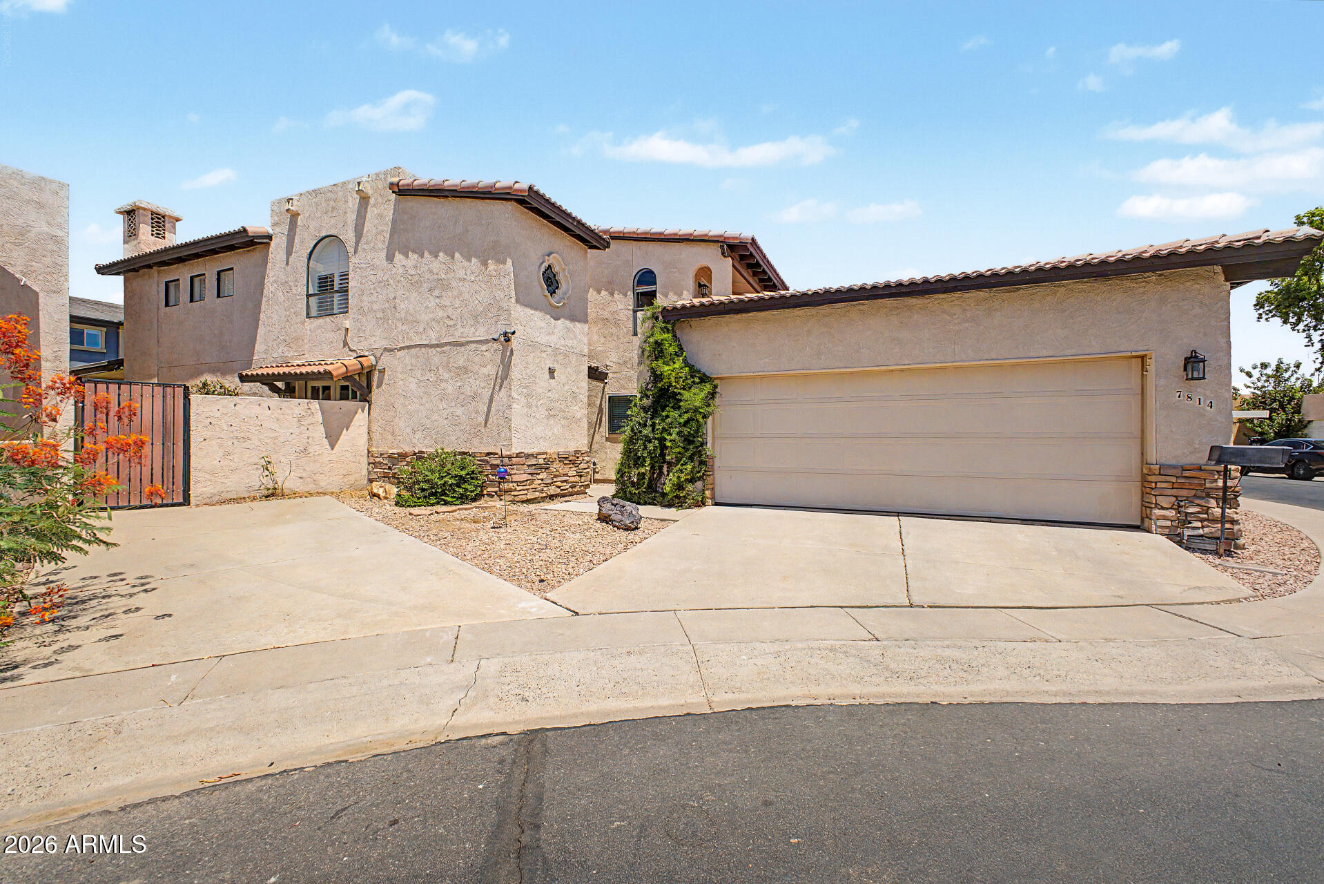 Enjoy a private gated community in central Phoenix near GCU! This updated 3 bed/2 bath home offers a functional two-level layout with a downstairs primary suite, two-tone paint, wood plank tile flooring, new water heater, and new roof. The main level features vaulted ceilings, a fireplace, side entry with double French doors, marble countertops, stainless appliances, pantry, and generous cabinet space. The primary suite has a walk-in closet and private patio access. Upstairs are 2 additional bedrooms, both with private balconies and a renovated bath with double sinks and tub/shower combo. A large loft offers flexible space for an office, media room, or additional living area. Backyard has a covered patio and planting space. The perfect location just 4.2 miles/10 minutes from GCU.