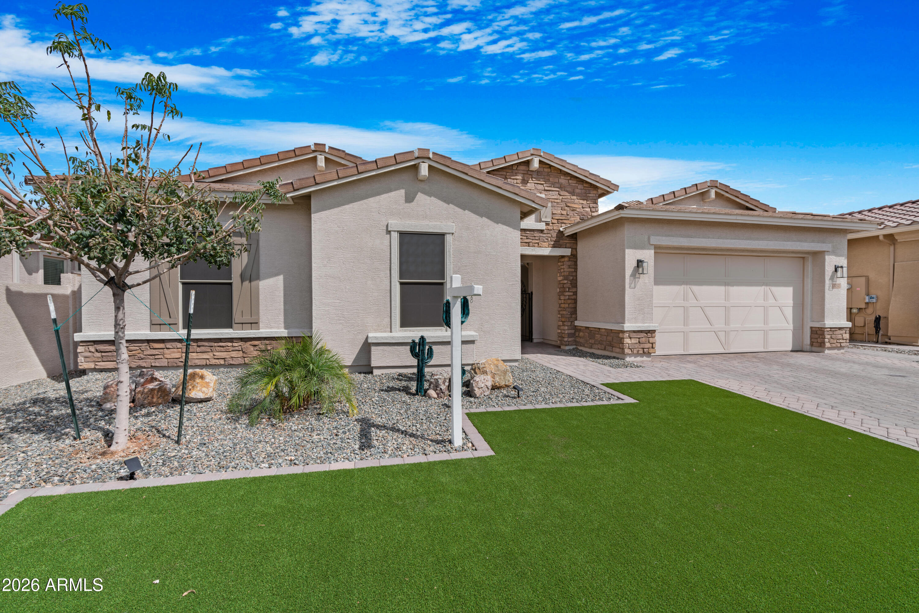 DISCOVER THE CHARM: Beautiful Move in Ready Home on a quiet cul-de-sac with custom touches throughout.  This homeowner has added everything you might want in a luxury home.  Enter through the Beautiful Waterfall glass front door.  The home features a spacious open floor plan with a Great Room and Gourmet kitchen.  The KITCHEN has plenty of counter top space and 42' white kitchen cabinets with 4'' crown molding, gas cook top with 5 burners and cast-iron grates, Whirlpool Smart 30'' SS double wall ovens with touchscreen, LG refrigerator and built in microwave and dishwasher.  The GREAT ROOM has a 3 panel multi sliding door to the backyard that extends your entertainment area. The BACK PATIO entertainment area is extended by a 36' x 12' covered pergola finished with the Weatherwood coating, ceiling fans, high grade Silver Travertine pavers, beautiful Dimension One Spa, high grade artificial turf and Silver Travertine step pads. A second covered patio area 16' x 12.5' is perfect for seating or fire pit. Solar wall mounted lights, enhance the beauty of the entire backyard and walkway at night. There is a Custom Storage shed 12'x 10' with overhang, built in work bench, shelving, and electrical.  And Gas is stubbed in to build your own BBQ. The Insulated 3 car garage has a Custom epoxy coating with 8' garage door perfect for larger vehicles, service door and ceiling fan and Mini Split AC unit NEW in 2025.  This home has exterior sun shades. It is light and bright, inviting modern elegance with 10' ceilings. All rooms have ceiling fans. Norwood Oak tile throughout. And Views of the Superstition and Dinosaur Mountains.