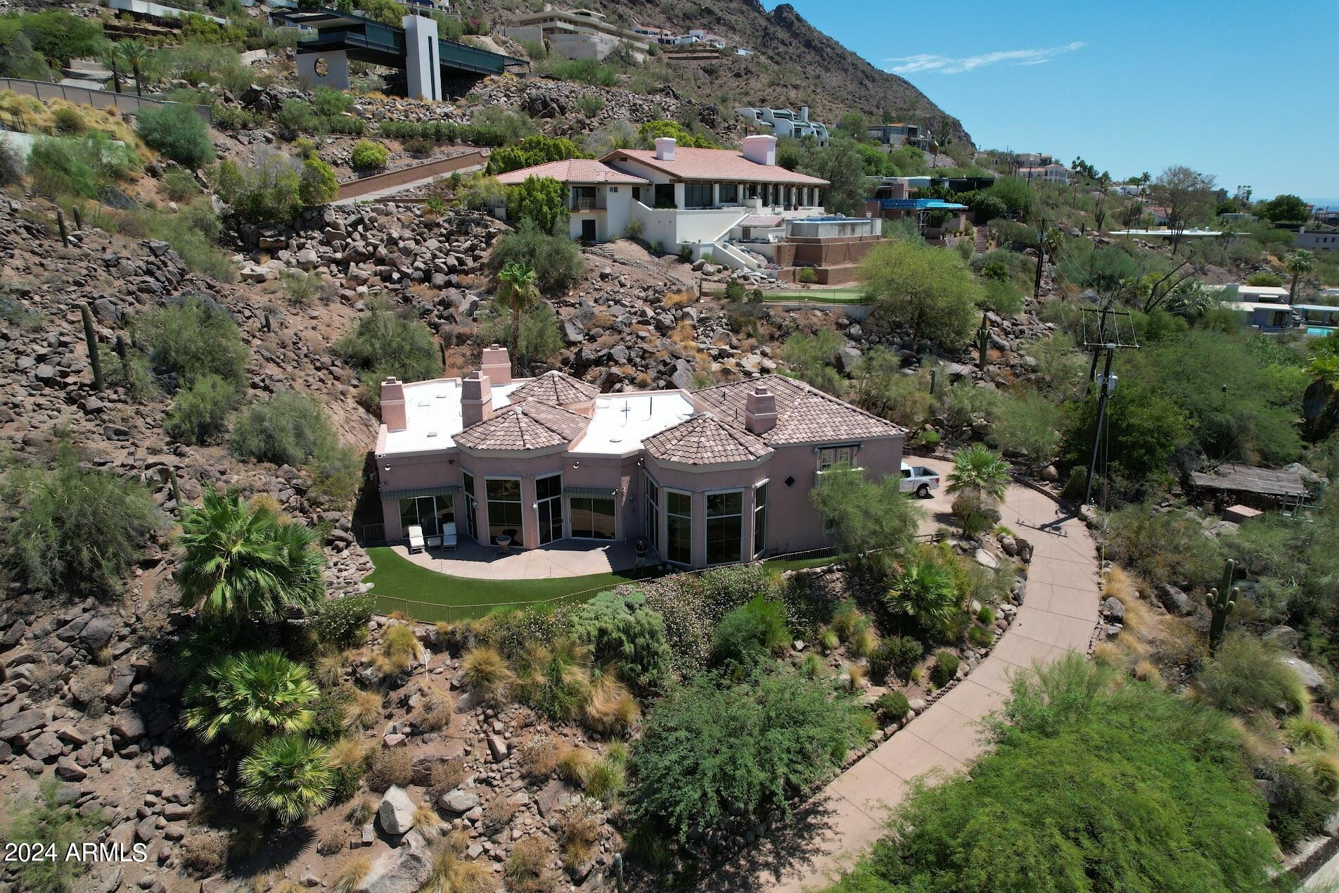 Live above it all! Nestled on an expansive acre lot on Camelback Mountain, this stunning property offers a serene desert landscape and awe-inspiring mountain views.

Living on Camelback Mountain offers a unique lifestyle with access to top hiking trails, breathtaking views, and close proximity to upscale shopping and dining in Phoenix and Scottsdale. This home presents a fantastic opportunity to customize and enhance its features with cosmetic upgrades, allowing you to infuse your personal style and transform this house into your dream home. Embrace the chance to create a luxurious haven with unbelievable views in one of Phoenix's most prestigious areas.
