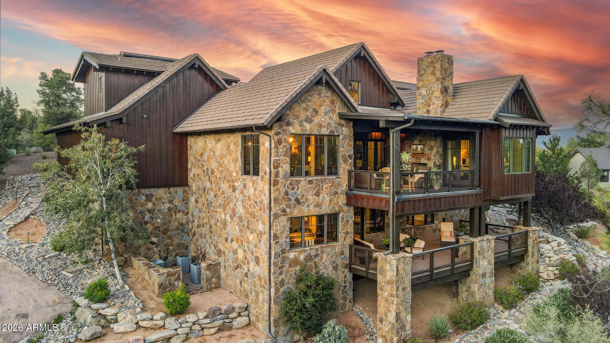 Welcome to refined living in The Rim Club, where timeless craftsmanship and the natural beauty of Rim Country come together to create an exceptional mountain retreat. Framed by captivating views of the Granite Dells and surrounded by the serenity of Arizona's high country, this fully furnished, custom residence offers a rare combination of luxury, comfort, and versatility. Rich reclaimed hardwood floors, exposed timber beams, and artisan craftsmanship create a warm yet refined aesthetic that feels both sophisticated and inviting. Walls of glass fill the home with natural light while showcasing the spectacular scenery beyond. Designed with both comfort and flexibility in mind, the home offers three private primary-style suites, each featuring its own en suite bath and walk-in closet, an ide eal layout for hosting family and guests while maintaining privacy for all. A fourth bonus room with an adjacent bath provides exceptional flexibility and can easily serve as an additional guest suite, bunk room, home office, fitness room, or private in-law retreat. The lower level is designed for entertaining and gathering, featuring a spacious game room and pool table, wet bar, conditioned wine room, and expansive covered patio that captures beautiful Granite Dells views. Whether hosting friends for the weekend or enjoying a quiet evening in the mountains, this level creates a seamless extension of the home's living space. Three gas fireplaces add warmth and ambiance throughout, while outdoor living areas and a custom fire pit provide the perfect setting for enjoying cool mountain evenings beneath star-filled skies. Thoughtfully designed with abundant storage, every detail has been carefully considered. Offering breathtaking scenery, flexible living arrangements, exceptional privacy, and timeless mountain elegance, this is a home designed to be enjoyed for generations.