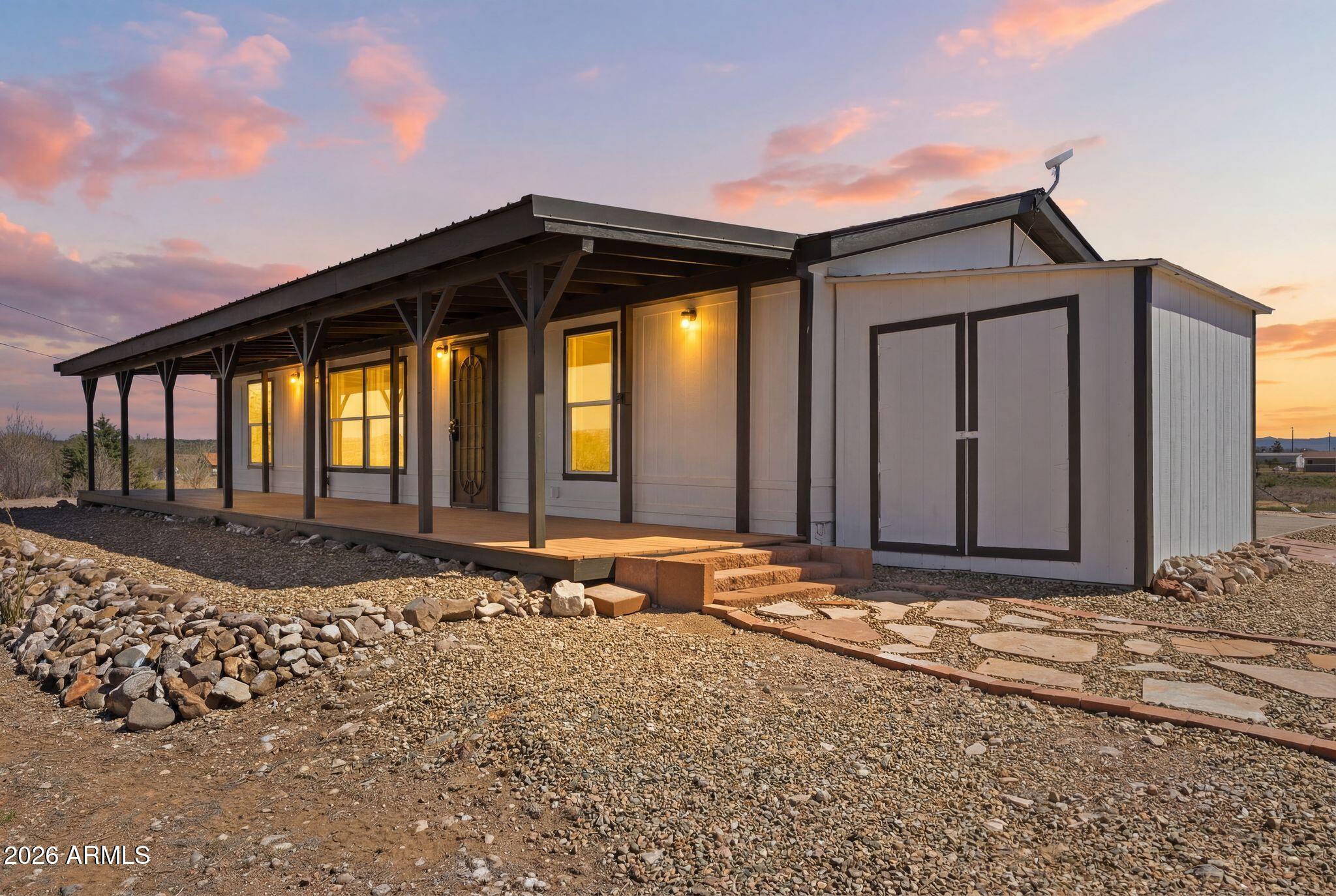 RENOVATED 2-ACRE EQUESTRIAN PROPERTY | PANORAMIC NORTHERN ARIZONA VIEWS | 2-STALL BARN Natural light fills this thoughtfully renovated home, where an open-concept floor plan opens to full-length covered porches. Every aspect of the home is designed to take in breathtaking hilltop views of public lands, valleys below, and distant ridgelines. Contemporary updates throughout include Lifeproof plank flooring, fresh interior and exterior paint, pinch-pleated draperies, and custom lighting are just a few of the improvements that create a retreat from daily life. The updated kitchen is equipped for both everyday living and entertaining with a 36'' Frigidaire Gallery 6-burner propane range featuring convection and air fry capabilities, a Bosch dishwasher, Whirlpool side-by-side refrigerator, butcher block countertops, and convenient counter seating for casual dining or morning coffee. The split-bedroom design offers added privacy for the primary suite, complete with an en suite bath featuring a dual vanity and deep soaking tub. All bedrooms have spacious walk-in closets. Equestrian amenities include a 2-stall barn with separate corrals, tack storage, electricity, lighting, and storage for up to 80 bales of hay. The large round pen has outdoor lighting and the property is fully fenced and features a new electric fence. Recent improvements to the home include a new roof (2023), new water heater, reverse osmosis system, new plywood subfloor throughout, programmable thermostat, new smoke and carbon monoxide detectors, and an FHA-compliant Engineering Certificate completed in March 2026. Surround yourself in Northern Arizona's peaceful high desert beauty and make this property your ideal backdrop for everyday living, outdoor recreation, and an equestrian lifestyle.