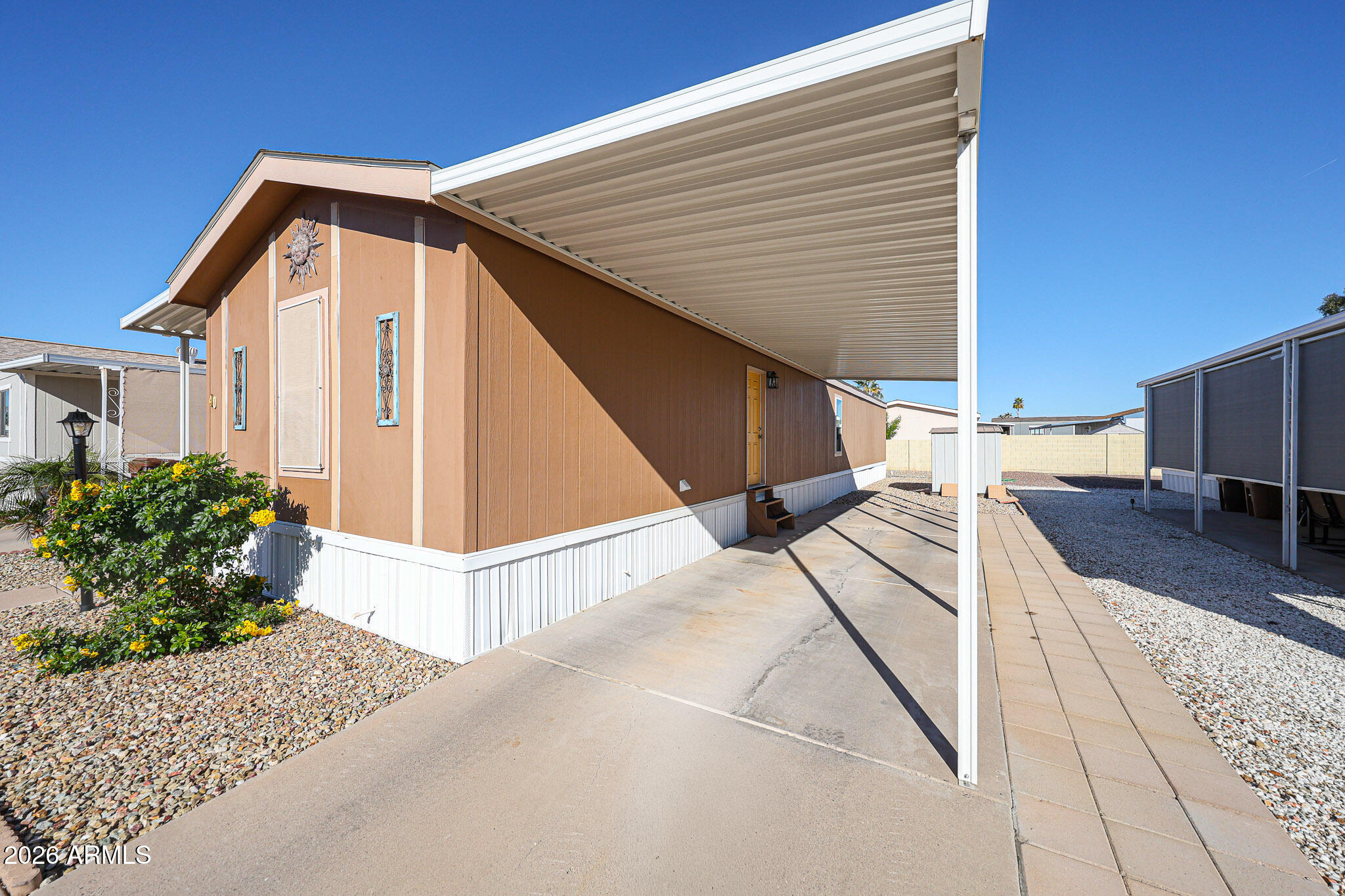 Welcome to easy, low-maintenance living in a well-kept mobile home community known for its friendly atmosphere and active lifestyle. This thoughtfully updated home offers fresh paint, attractive flooring throughout, and a bright, open layout that flows effortlessly from the kitchen into the main living space-perfect for everyday comfort or hosting friends. The kitchen provides ample cabinetry and prep space, while the split floor plan offers privacy and flexibility for guests, hobbies, or a home office. Outside, enjoy covered parking and desert landscaping designed for simple upkeep. The community features resort-style amenities including a clubhouse, swimming pool, planned social activities, and beautifully maintained grounds, all conveniently located near shopping and dining.