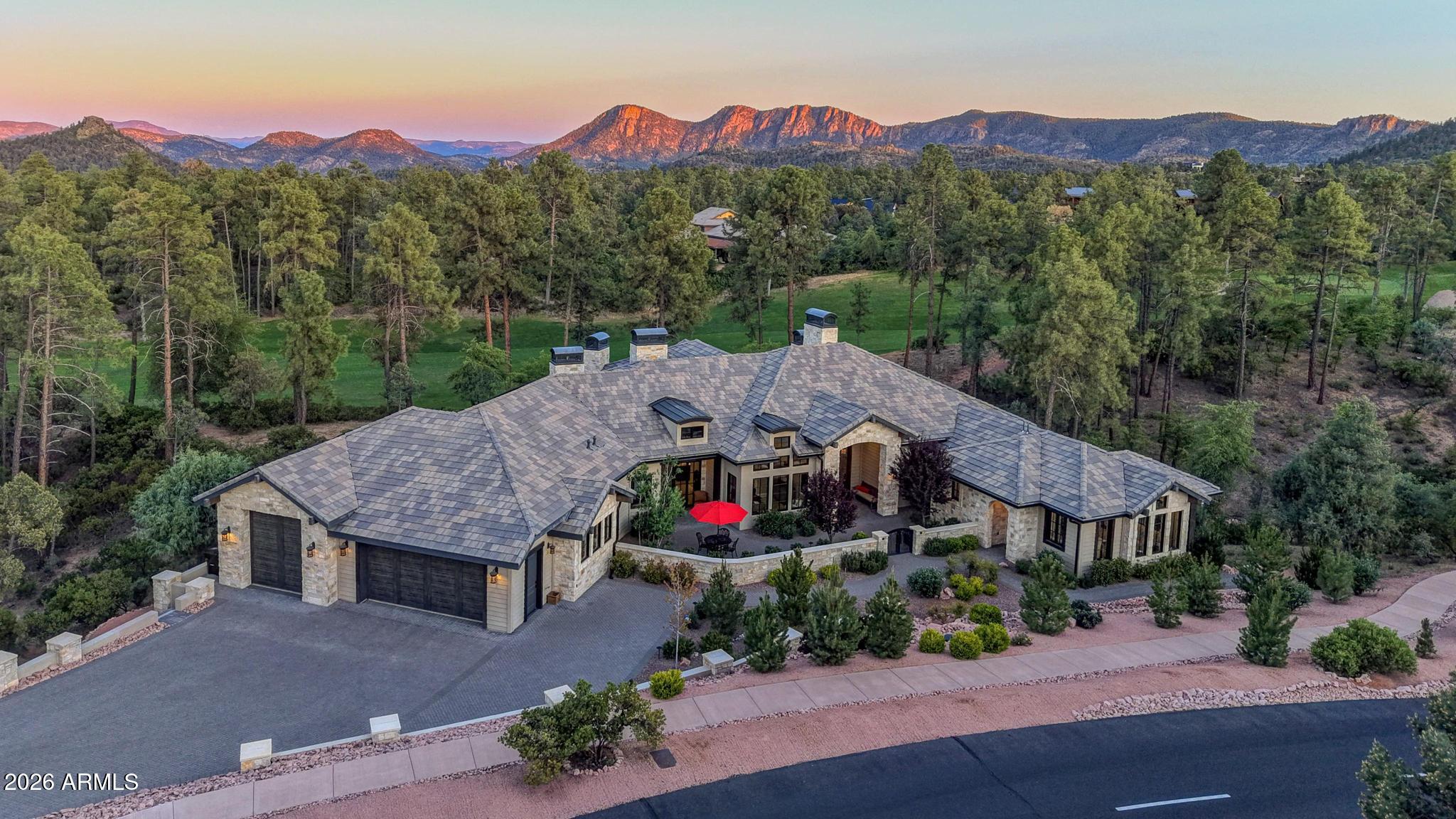 This is one of the most distinguished homes to become available in The Rim Golf Club, a custom mountain estate set on a nearly two-acre homesite with approximately 600 feet of golf course frontage overlooking the scenic 2nd hole. Private and positioned to capture sweeping golf course views, surrounding pines, and the striking Granite Dells beyond, this property stands apart for both its setting and architectural presence.
Blending timeless architecture with subtle French Country and European influences, the home showcases award winning exterior stonework, warm natural materials, and extraordinary custom craftsmanship throughout.
Offering approximately 3,763 sq' of living space (6,578 sq' under roof). The main residence includes three bedrooms, 2.5 bathrooms, and a dedicated office which can also serve as a beautiful dining room.  A casita adds a private bedroom and bathroom, along with a kitchenette and its own balcony, creating a comfortable space for guests, nanny/caretaker or private in-law retreat.  

  Inside, the chef's kitchen is a true centerpiece, featuring dual islands with dual sinks, a coffee bar with sink, and premium finishes throughout, including a fireplace in the dining space that adds warmth and character.  Wood beams and coffered and tray ceilings, antiqued solid alder doors, tongue and groove exterior ceilings, and five gas fireplaces are just a few of the custom details that speak to the quality of the home, with so much more to experience. The gallery hallway is defined by beams, tongue and groove ceiling and herringbone flooring that carry throughout, creating a seamless architectural connection as you move through the home.   

 As you enter the primary suite, the coffered ceiling sets the tone for the space, opening into a generously sized room anchored by a fireplace with custom stonework. Expansive windows frame views of the surrounding pines, while private wraparound deck access extends the space outdoors. This is an area designed entirely for you, where privacy is absolute and neighboring properties feel worlds away.  

 Continue into the primary bath, where a spa-like setting features a soaking tub positioned beneath a stunning arched window looking out to the pines.  The closet features a Juliet balcony with double doors to open and welcomes the fresh mountain air.  

To take full advantage of Payson's climate, over 1,200 square feet of outdoor living was designed, including a covered paver patio with a built-in grill and gas fireplace.  A fully fenced outdoor area provides flexible space for pets, play, or gathering, while a stone arch frames views of the golf course and the surrounding towering pines.  

The 1,600 square foot garage includes an RV garage designed for small to mid-size RVs.  The large paver driveway adds additional parking and turnout areas.  The garage has a 220 outlet for electric vehicle charging.  

 Additional features include 40 solar panels, a whole house attic fan, reverse osmosis water to five sinks, a water softener and conditioning system, automated landscape lighting and irrigation, recently fire wised grounds, a buried 1,000-gallon propane tank, and a security system with motion detectors.  

Located in one of Arizona's most prestigious private golf communities, The Rim Club offers an unmatched lifestyle surrounded by cool temperatures, pine forest, dramatic scenery, and championship golf.  With dual access to both The Rim Golf Club and Chaparral Pines creating one of the region's premier private golf and lifestyle destinations.  

 A home of this caliber, with this lot, this setting, and this level of craftsmanship, rarely becomes available.