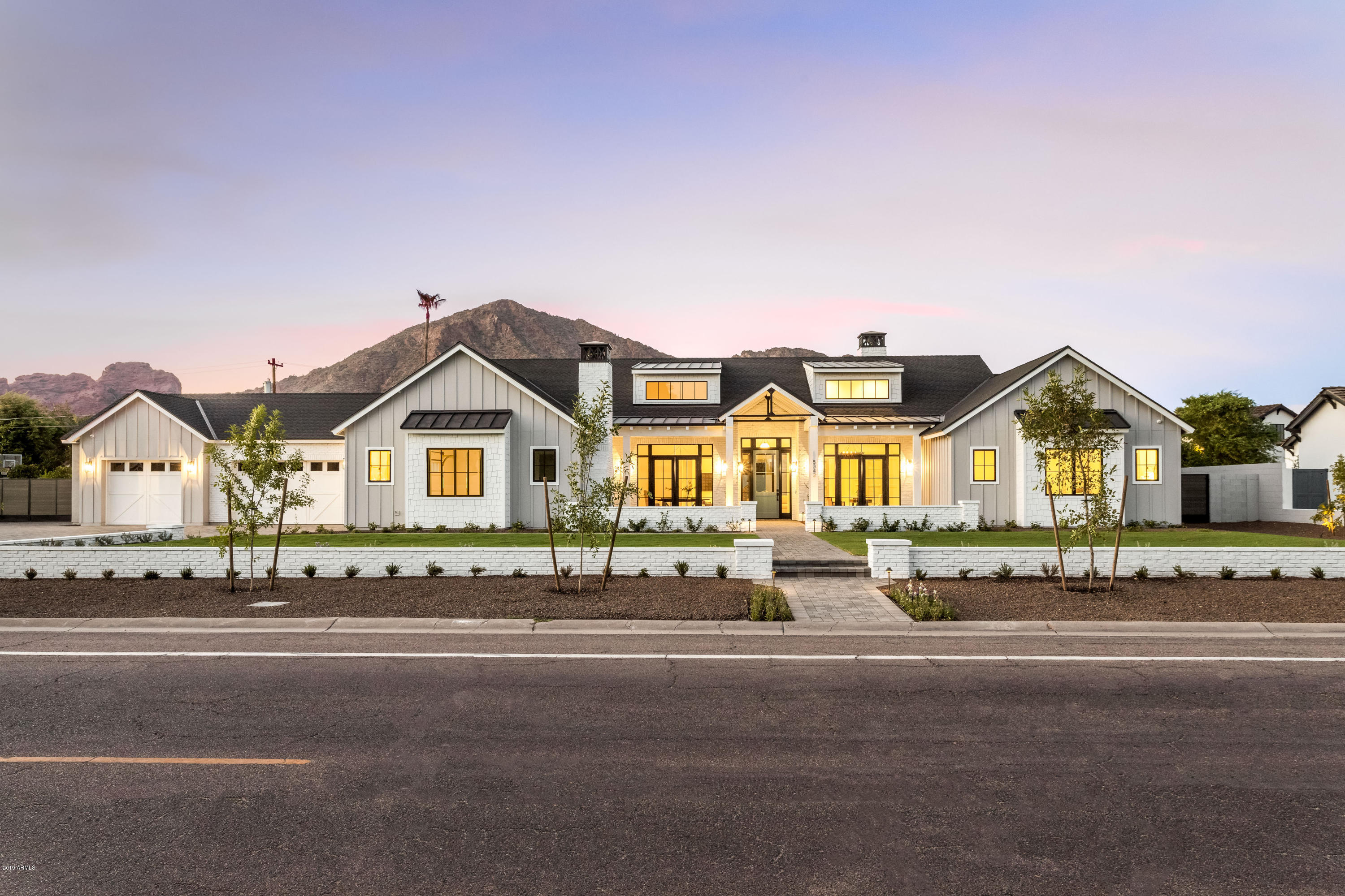 True to its elegant farmhouse charm this home will not disappoint...from the second you enter the front door you realize this is a special property. The design has the perfect blend of modern & sophisticated finishes w/ touches of natural oak that bring warmth to gracious living spaces found throughout the home. The greatroom is appointed w/ 20ft tall dormers that maximize natural light & highlight the stained rough sawn beams making a bold statement when entertaining guests. This exquisite home encompasses the true meaning of indoor/outdoor living, including a 717 sqft guest house & gracious patios that extend entertaining space out to nearly a 3/4 acre lot, all while enjoying iconic Camelback Mountain as your backdrop.  The stainless steel & gold clad range hood provides this gorgeous... ....kitchen with a center piece that is near perfection that will be admired while sitting at the oversized island or eating in the breakfast nook during the morning sunrise . The Chef's Kitchen includes a Wolf & Subzero appliance package, custom cabinetry by Burdette & a pantry that provides additional storage. Even the laundry room & mudroom have a distinctive touch that can't be ignored. 

The Master Suite's spacious private retreat includes a coffee/beverage bar that ties in perfectly w/ the natural oak vanities  & expansive walk-in closet. Each bedroom is appointed w/ its own unique bathroom & walk-in closet that provides enough room for everyone.

This stunning creation from Rebuild the Block is a must see for anyone who wants to truly embrace the Arcadia lifestyle.
