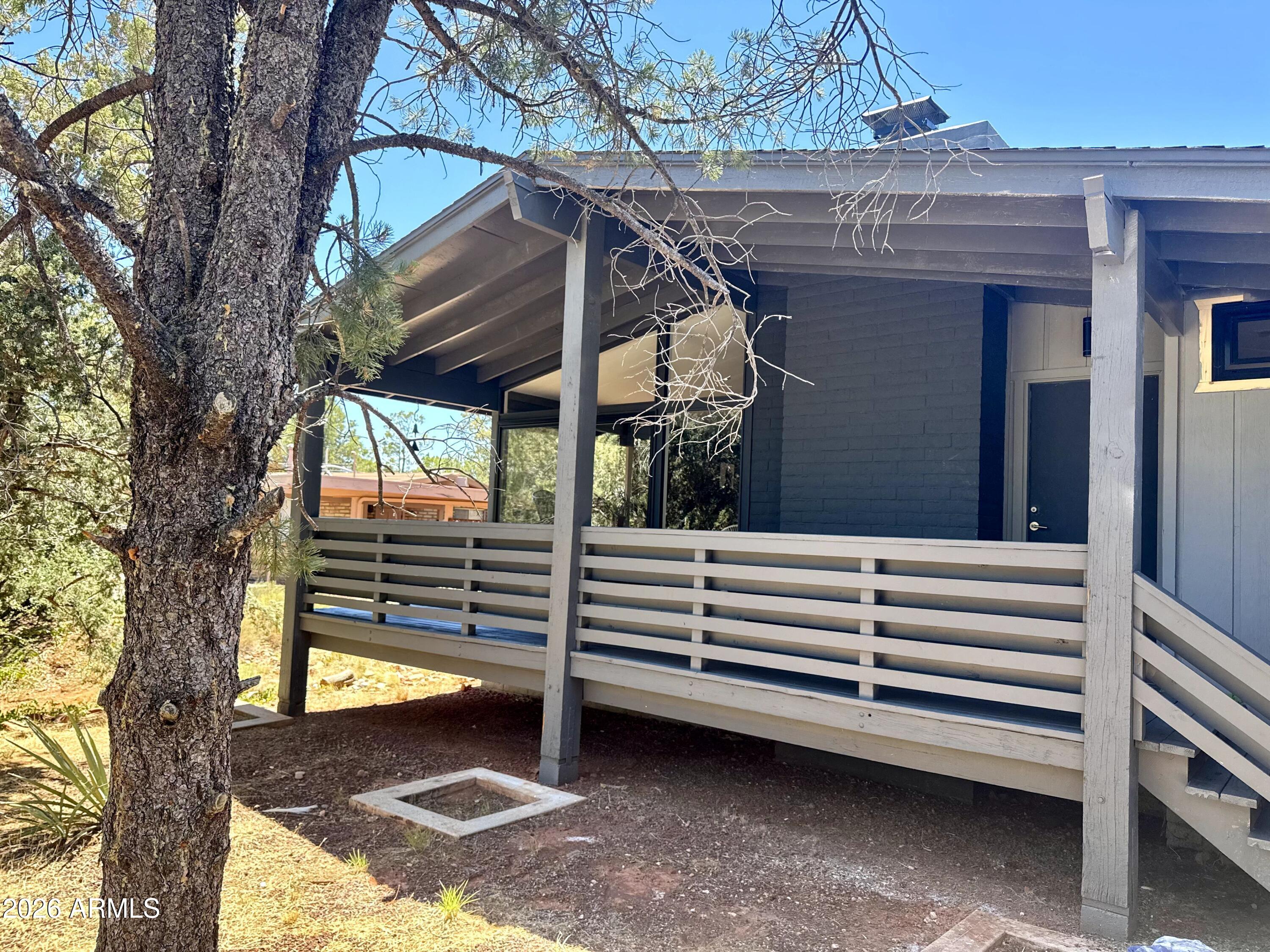 Stylish, updated mid-century modern with red rock views, on .44 acre.  Convenient to all Sedona and VOC activities, yet secluded by winding roads and wooded hillsides. Quaint covered front porch, wood burning fireplace, private drive to separate studio/casita and insulated garage with mini split heat/cooling, & canned lighting for art studio or fitness room.  1427 sq ft main house and 256 sq ft casita = 1728 sq ft total. Updates in last 5 years include roof, doors, windows, interior and exterior paint, flooring, kitchen cabinets & countertops, baths, master closet, tankless water heaters in home & casita, secure network and Ring Security System, Hvac in home & mini-splits (in guest house & garage).   Appliances are apx 5 years old.  Minimum rental is 30 days per the HOA.