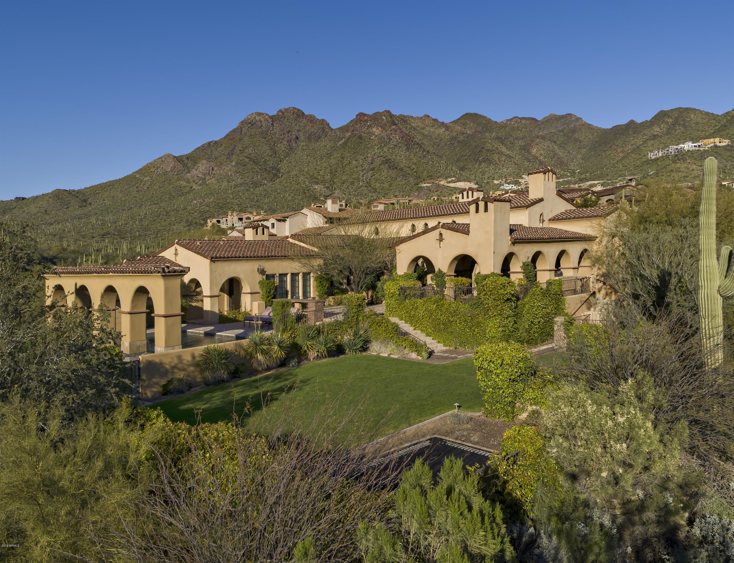 Celebrate the good life in this spectacular custom sanctuary boasting city light views, exceptional sunsets and pristine mountain vistas in every direction. Privacy is the cornerstone of this home, tucked away on 2 generous acres backing to the preserve in the Upper Canyon, in the prestigious community of Silverleaf. This single story, split floor-plan house is the 'right size' at just under 5700 square feet. It is light and bright and captures the very essence of desert living with generous indoor & outdoor venues for entertaining or relaxing. Luxurious finishes and superior craftsmanship raise the standard of the property by featuring an extensive use of hardwood floors, hand hewn wood beams, custom cabinetry, and superior brick, stone and metal craftsmanship. A spectacular gourmet kitchen anchors the home and is designed for easy entertaining, with a center island, custom cabinetry, and the high-end appliances one would expect in a home of this caliber. 
 
The generous master retreat is luxurious and split from the two en-suite bedrooms. Oversized windows capture light and views, and the bath and closet space compliment the space perfectly.
 
 
The executive office makes working from home a joy, while the theatre room is on point for entertaining and movie night. There is little room for excuses, with easy access to a personal in-house gym. And family and friends will delight in the private guest casita, located upstairs, with access from the main home as well as the front courtyard. The casita includes a bedroom, bath, sitting area with kitchenette and balcony with stellar views of the McDowell Mountains. 
 
Outdoor living at its best, with a pool and spa that overlook a mountain through an arched decorative wall. An outdoor dining area complete with BBQ, fireplace and TV, plus a center plaza and an event lawn with in ground trampoline, provide plenty of space for larger outdoor events. 
 
The 4 car garage has epoxy flooring and enjoys lots of storage space with custom cabinetry and extra room for toys. This home has it all and is not to be missed!
 
*Silverleaf residents enjoy amenities such as guard gated entry, roving security, hiking trials, walking baths, community centers with fitness, lap pool, spa, (2) lighted tennis courts as well as basketball courts and children's park. There are also (2) country clubs with golf and social memberships available: Silverleaf Country Club and DC Ranch Country Club.