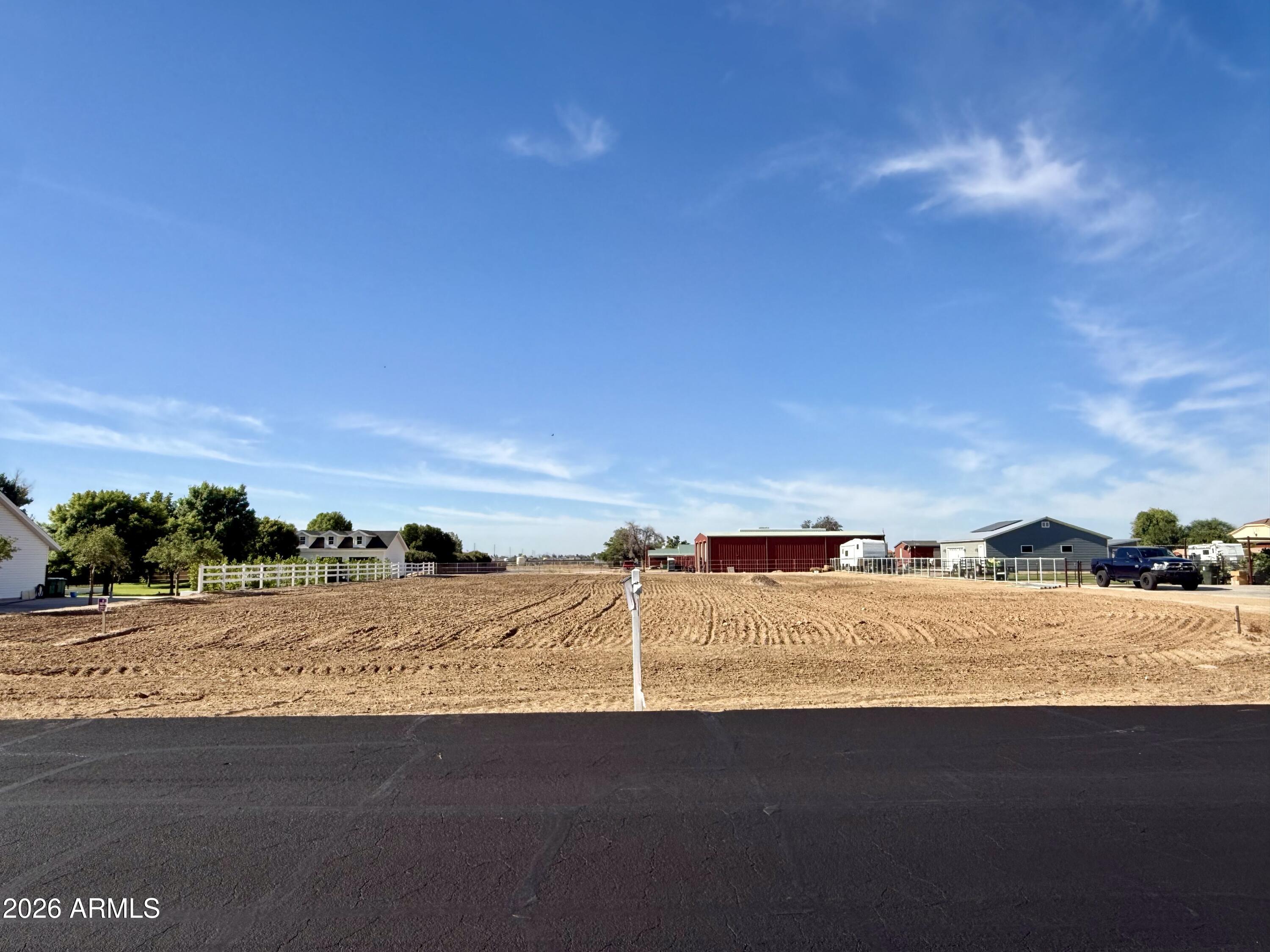 Looking for The Perfect Lot for your custom home? This rare opportunity came up. Vacant irrigated lot with paved road and all the services and utilities. Start working on your floor plans and build your home exactly the way you want it. Desirable North/South orientation. Perfect distance from the 303 Loop or the I-10.  The lot is flat and 100% usable. Don't miss this rare opportunity. 
Small, beautiful and quiet community of custom homes in the perfect location, Buyer to verify all information. Owner/Agent. Seller may carry with 50% down. Epcor water company. APS.