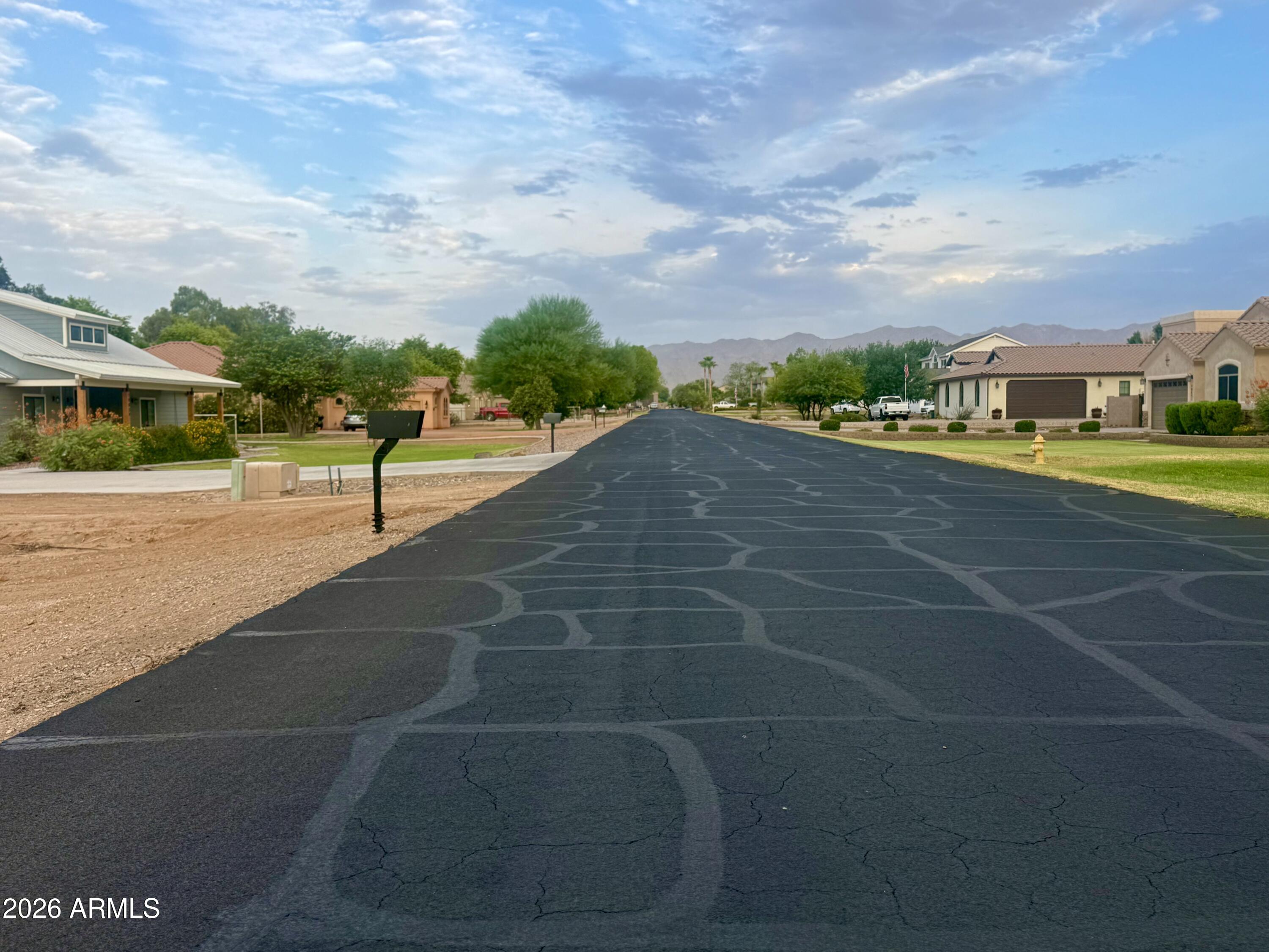 Looking for The Perfect Lot for your custom home? This rare opportunity came up. Vacant irrigated lot with paved road and all the services and utilities. Start working on your floor plans and build your home exactly the way you want it. Desirable North/South orientation. Perfect distance from the 303 Loop or the I-10.  The lot is flat and 100% usable. Don't miss this rare opportunity. 
Small, beautiful and quiet community of custom homes in the perfect location, Buyer to verify all information within 10 days after contract. Owner/Agent. Seller may carry with 50% down. 
Epcor water company with the water meter already installed. 
APS for electricity.
Flood irrigation already installed with 8 in pipe.
Agent can provide additional information.