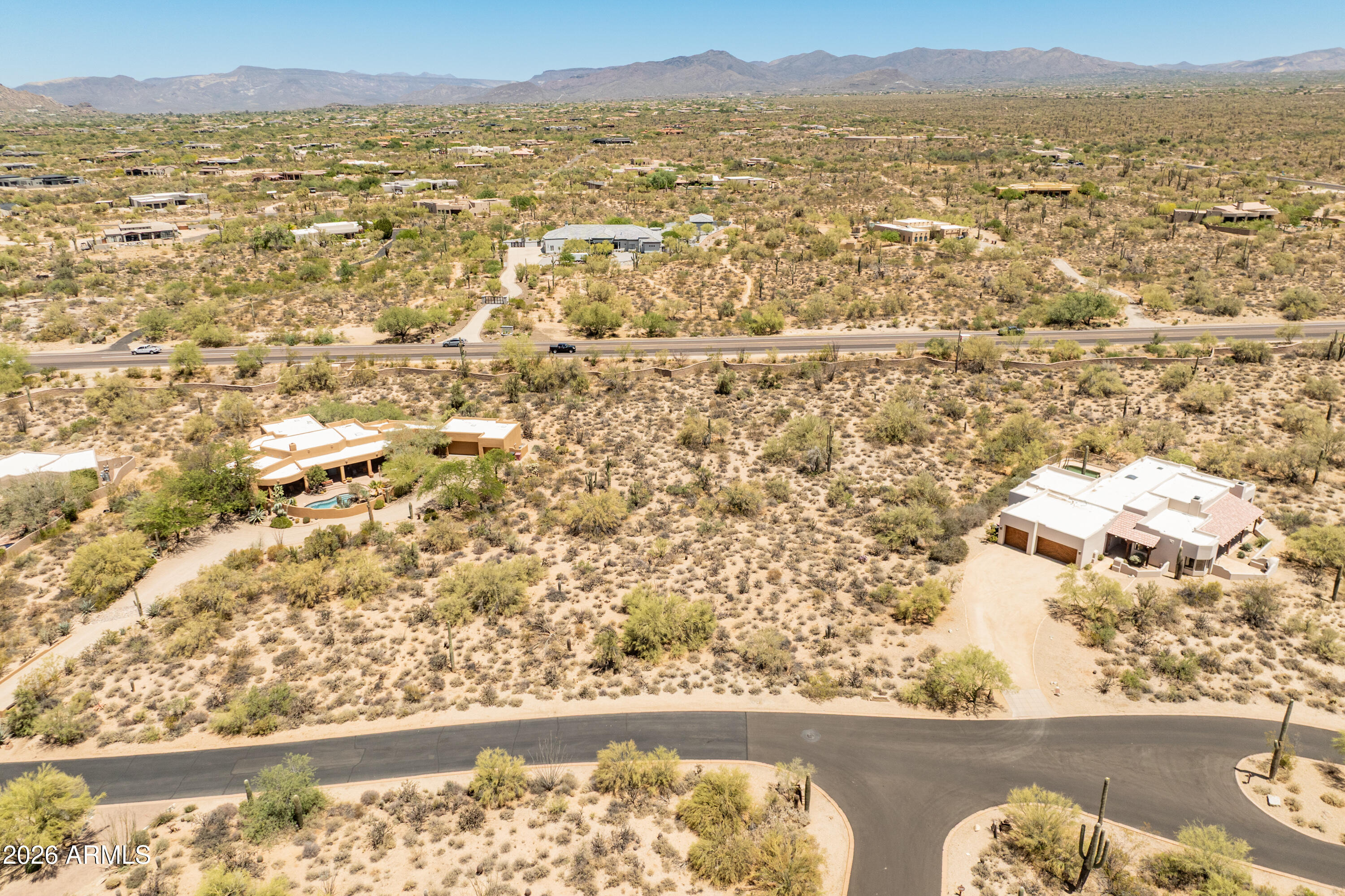 Lot 2 in desirable guard gated Sincuidados. 1.42 acre parcel in an established neighborhood ready for your dream home in North Scottsdale. Buyer to confirm building envelope size of 17,700. Sincuidados ''without care'' in Spanish, features a guarded gate, clubhouse, pickleball/tennis and basketball court.   Please see additional MLS listings for vacant lot 4, Residence on Lot 3 and Listing for all 3 parcels together.   If you want lots of land and privacy this is for you.  Few communities can boast owning a mountain and its surrounding preserve. There's more than 100 acres of hiking trails inside the community as part of the Sincuidados Community Lone Mountain Preserve. See community website at Sincuidados.org for more info about this amazing neighborhood.